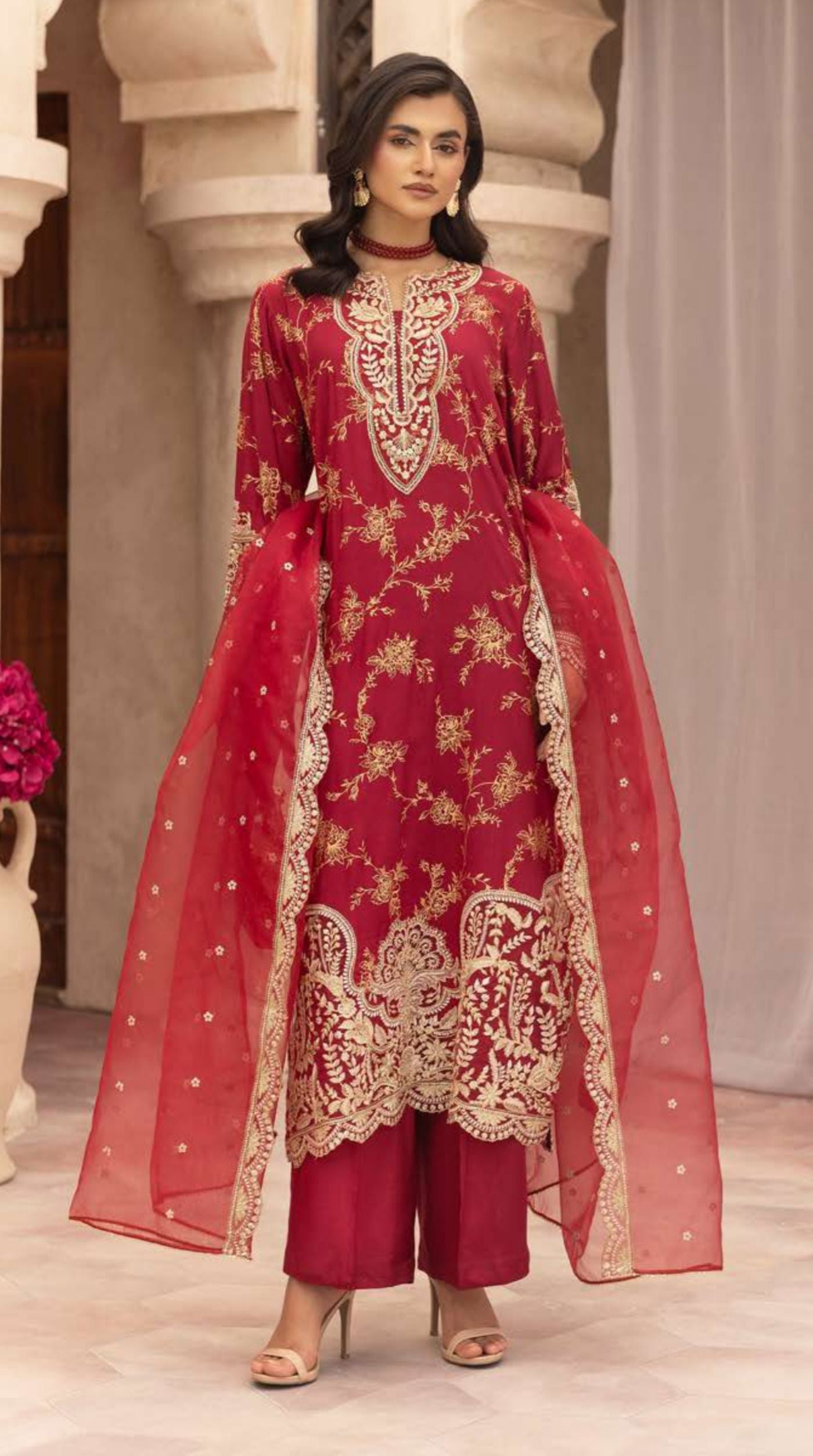 Ruby red embroidered viscose suit set featuring intricate floral embroidery and a sheer embellished net dupatta.