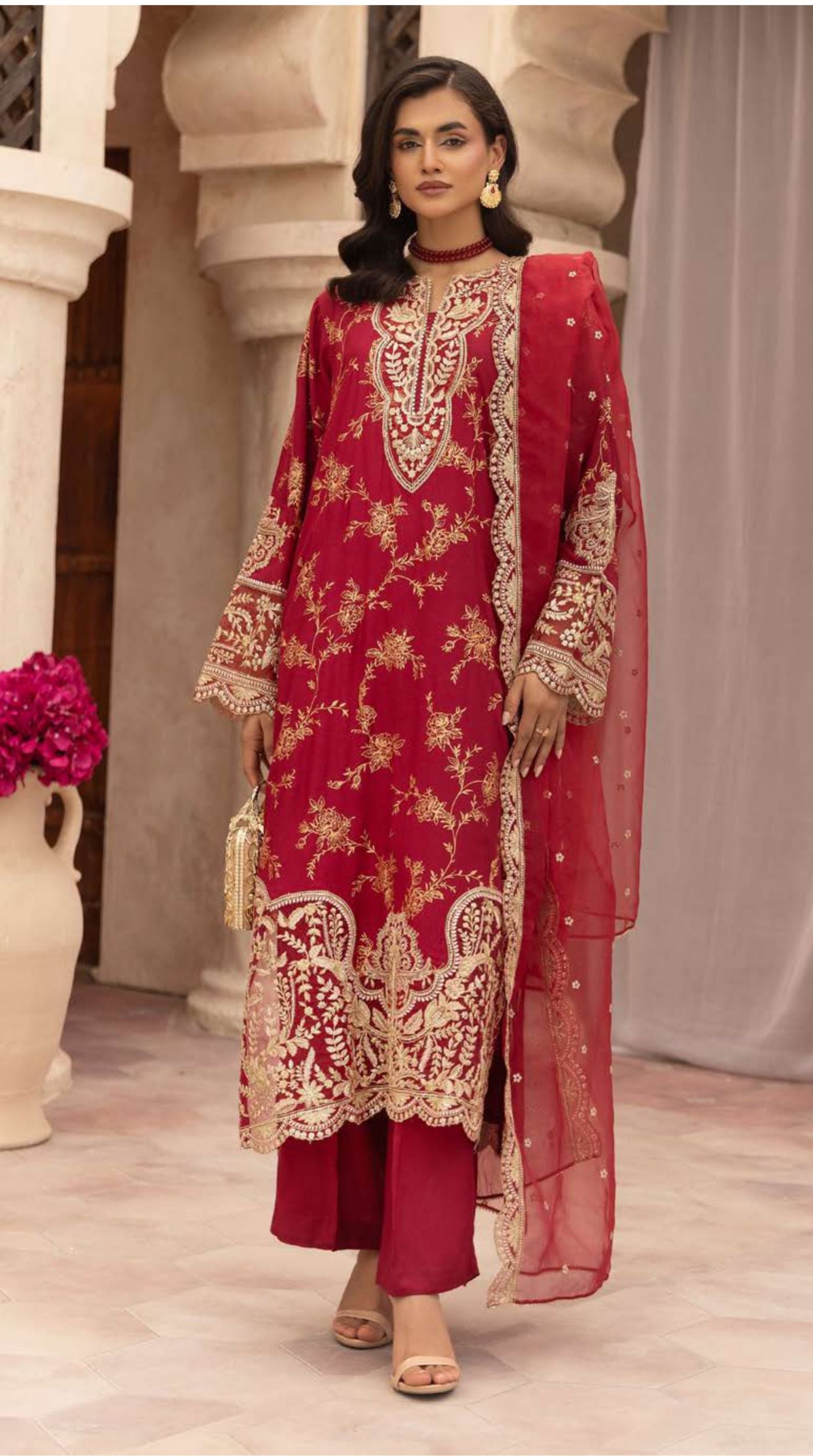 Ruby red embroidered viscose suit set featuring intricate floral embroidery and a sheer embellished net dupatta.