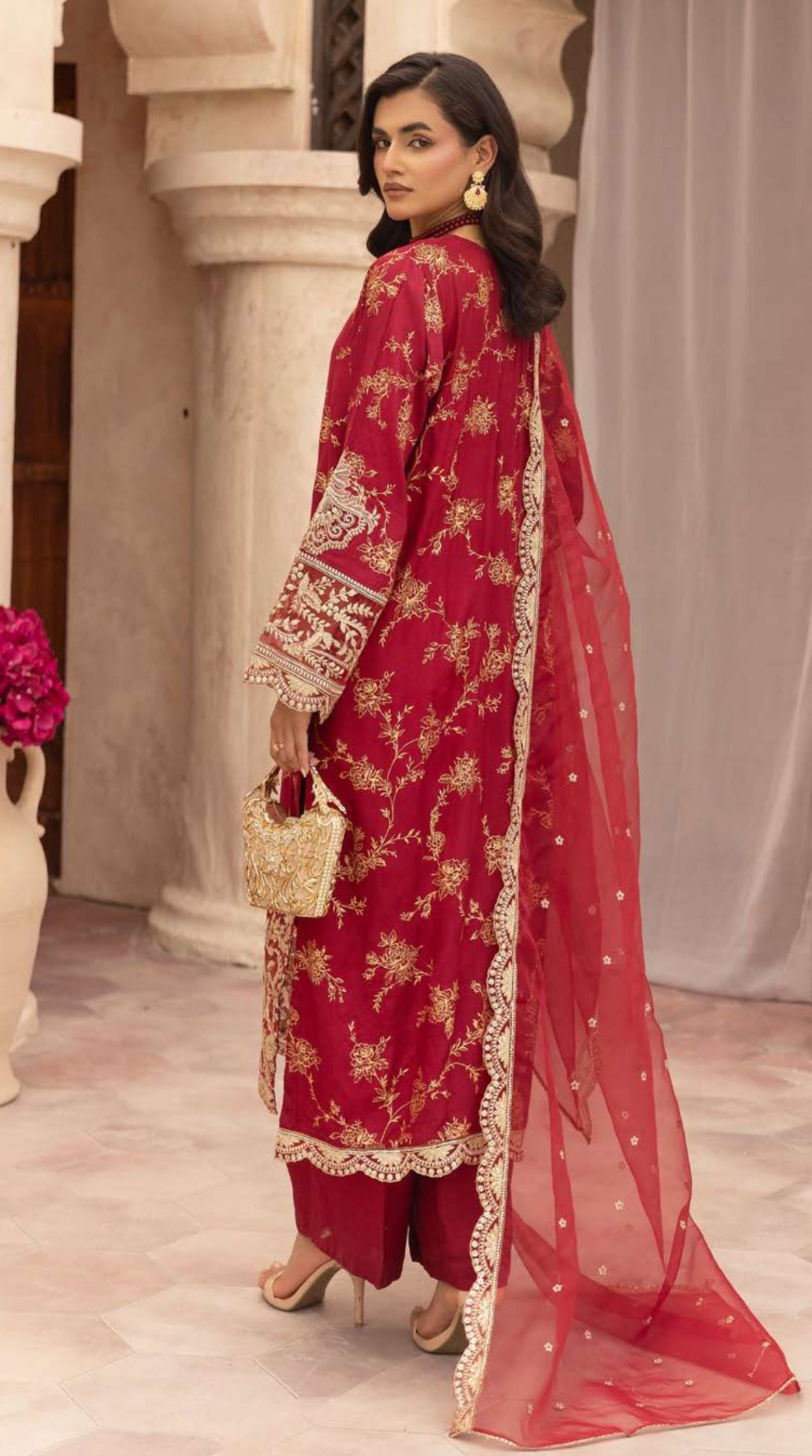 Ruby red embroidered viscose suit set featuring intricate floral embroidery and a sheer embellished net dupatta.