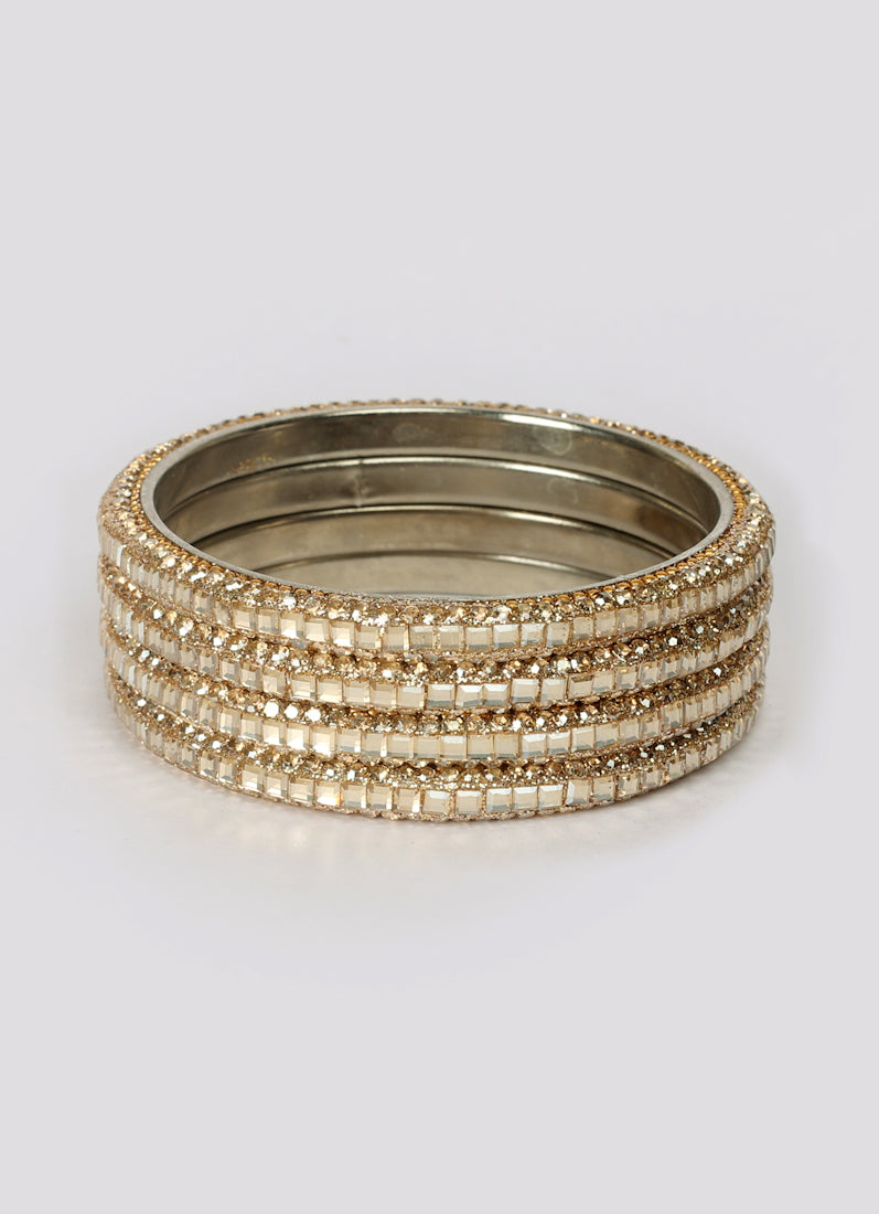 Close-up diamante detailing on gold colour bangles