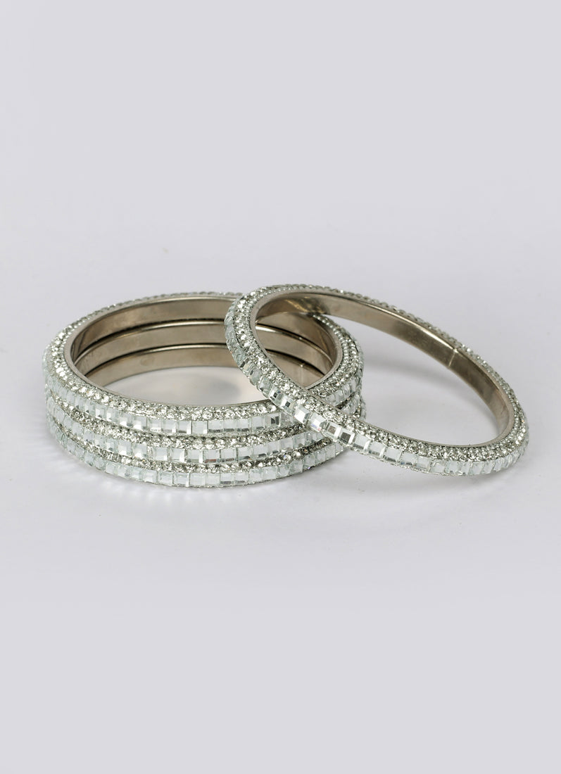 Close-up diamante detailing on silver colour bangles