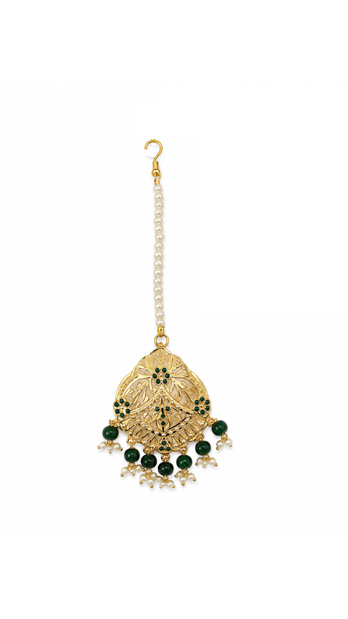 A traditional Indian gold-toned Jadau maang tikka.