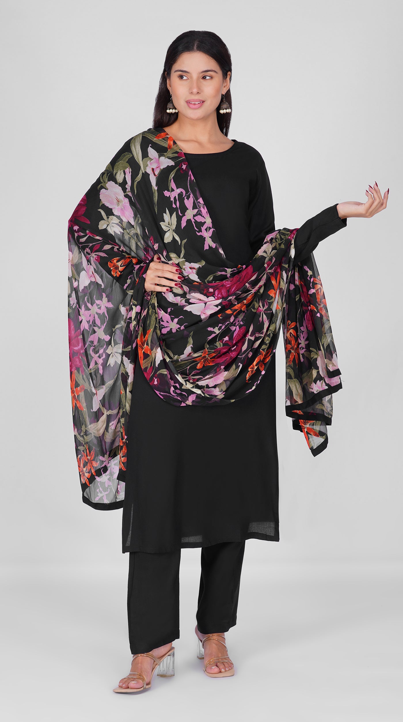 Black straight cut suit set modeled with a plain black kurta and pants paired with a sheer floral georgette dupatta in pink, purple and orange tones