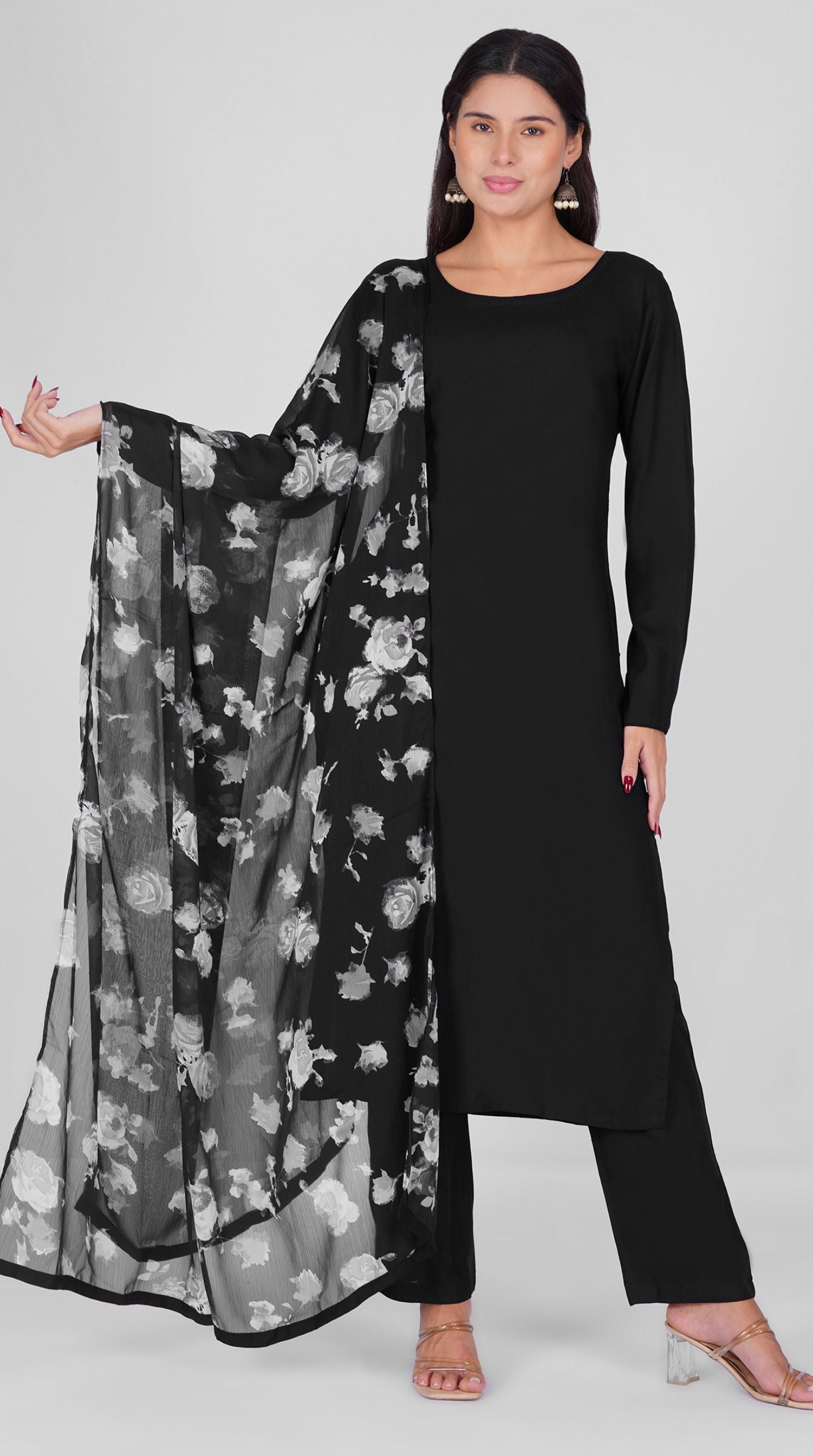 Black straight cut suit set modeled with a plain black kurta and pants paired with a sheer monochrome floral georgette dupatta