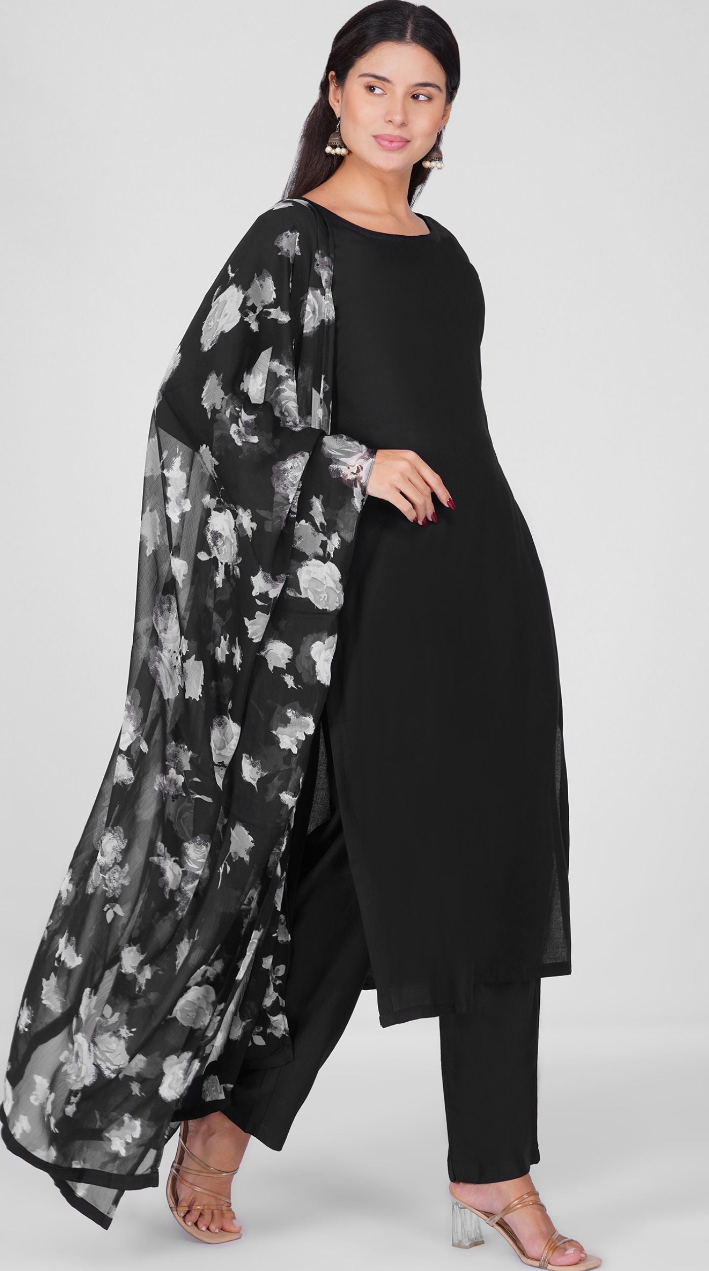 Black straight cut suit set modeled with a plain black kurta and pants paired with a sheer monochrome floral georgette dupatta