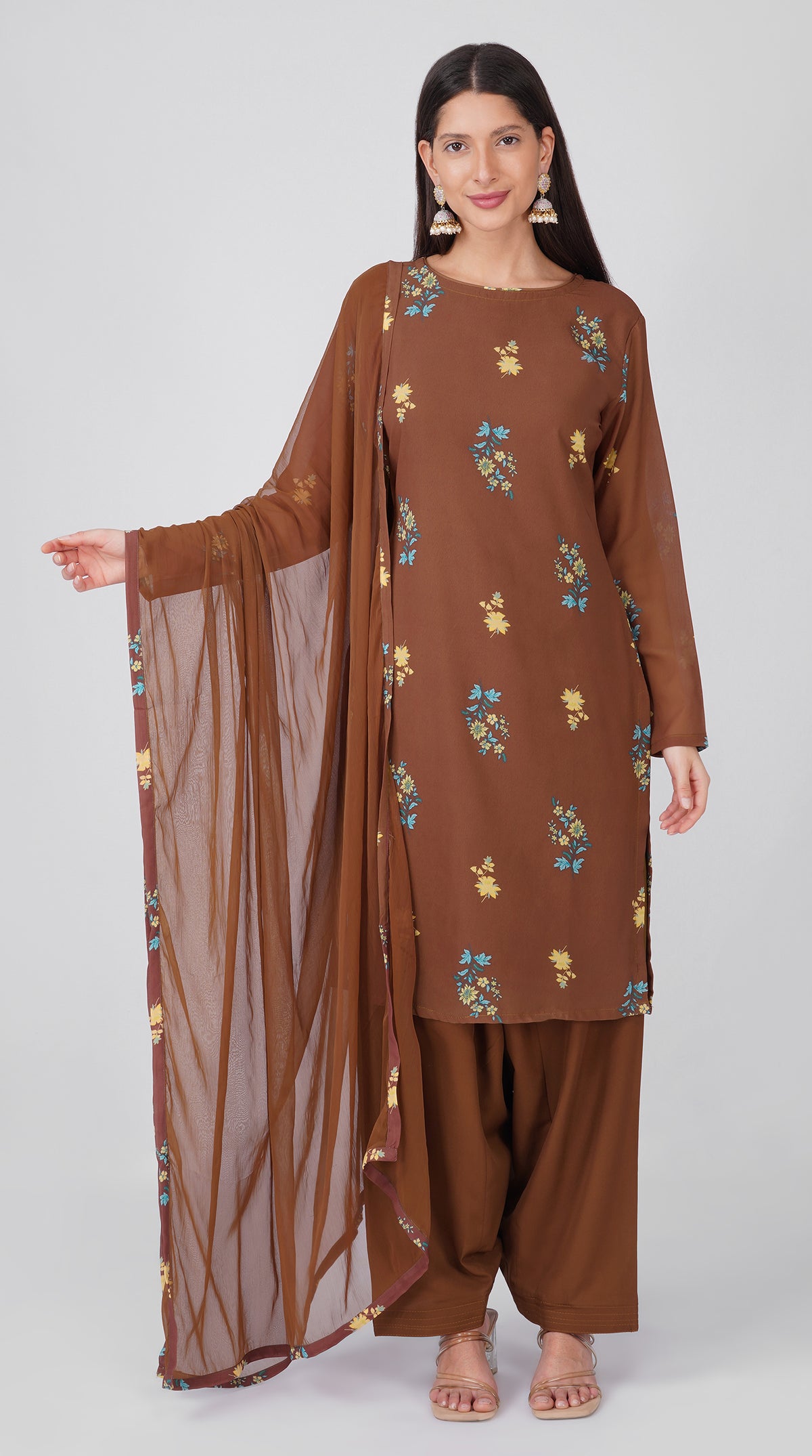 Women’s brown georgette printed suit set with shift kurta, crepe salwar and chiffon dupatta featuring four-sided printed patti detailing.