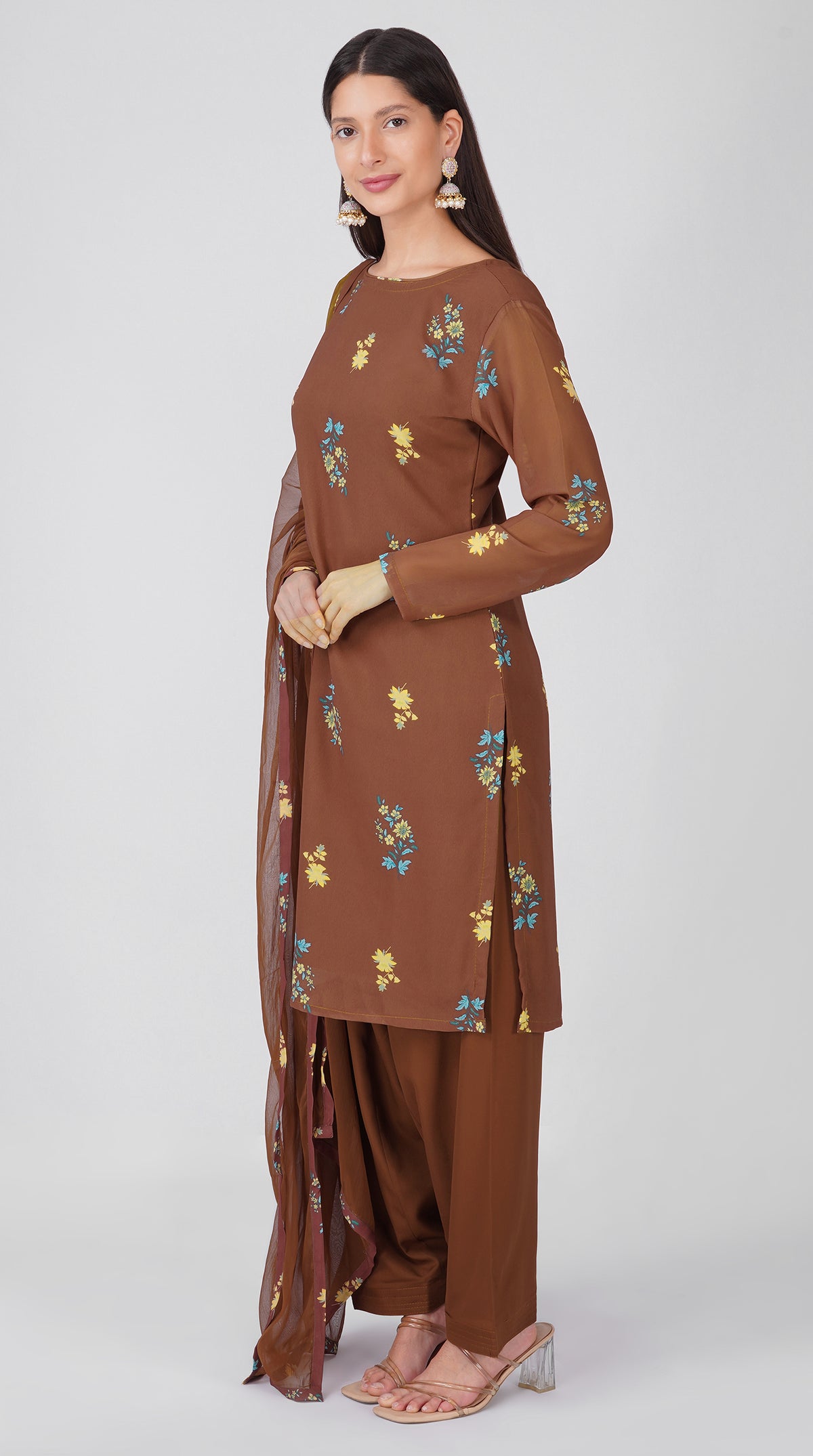 Women’s brown georgette printed suit set with shift kurta, crepe salwar and chiffon dupatta featuring four-sided printed patti detailing.