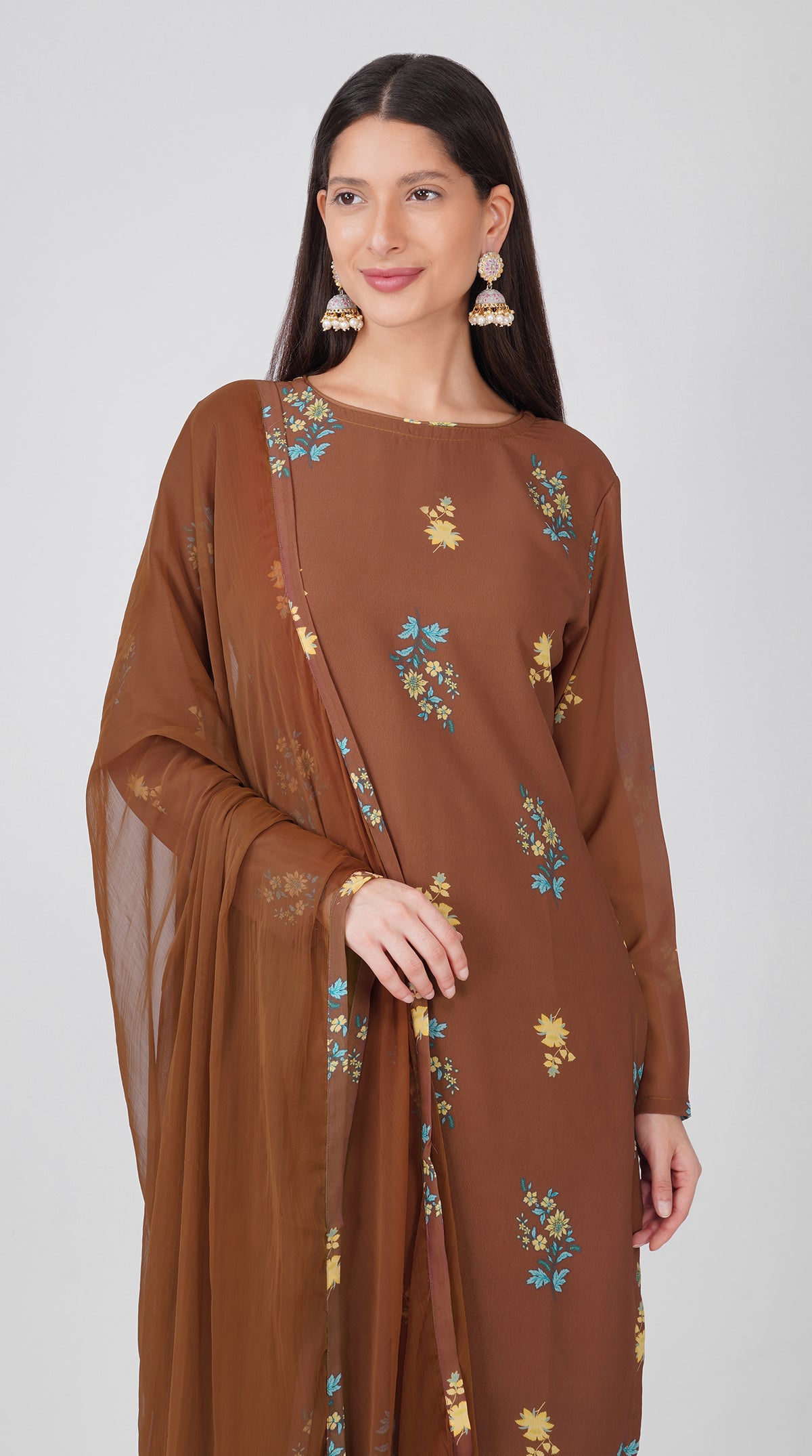 Women’s brown georgette printed suit set with shift kurta, crepe salwar and chiffon dupatta featuring four-sided printed patti detailing.