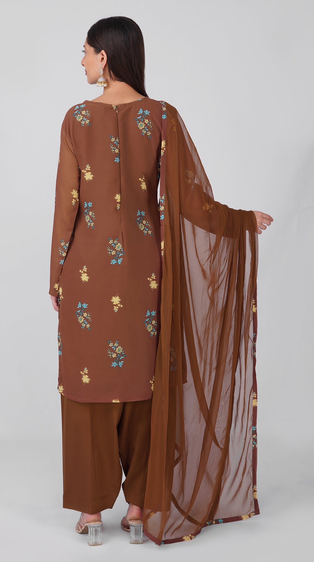 Women’s brown georgette printed suit set with shift kurta, crepe salwar and chiffon dupatta featuring four-sided printed patti detailing.