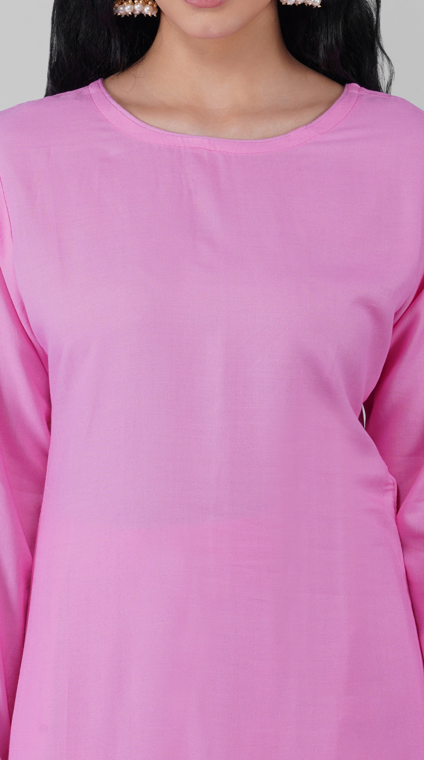 Close-up of plain pink rayon kurta and neckline