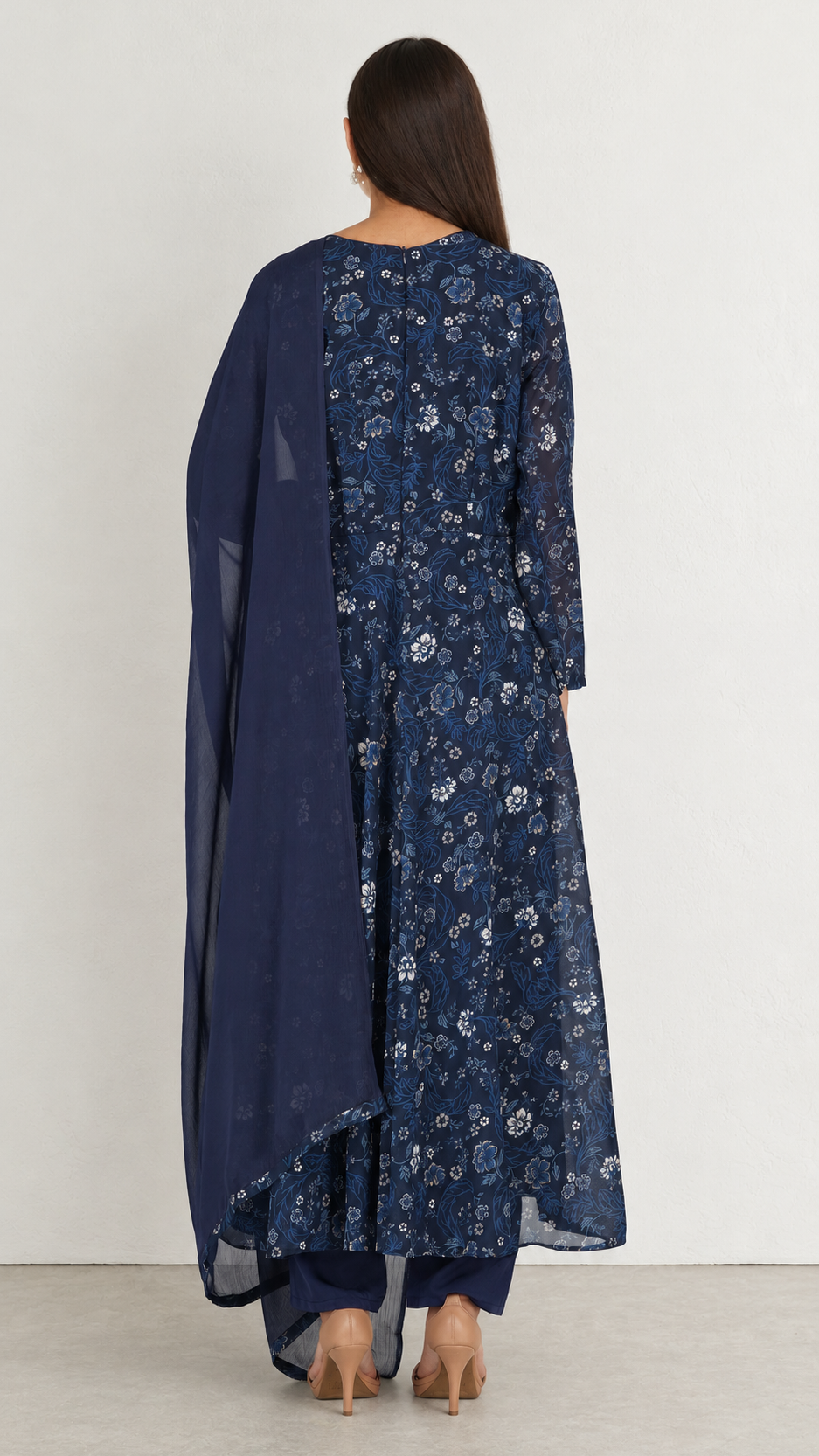 A woman shown from the back wearing a navy blue embroidered kurta with a matching sheer dupatta and navy pants, photographed against a plain light gray studio background.