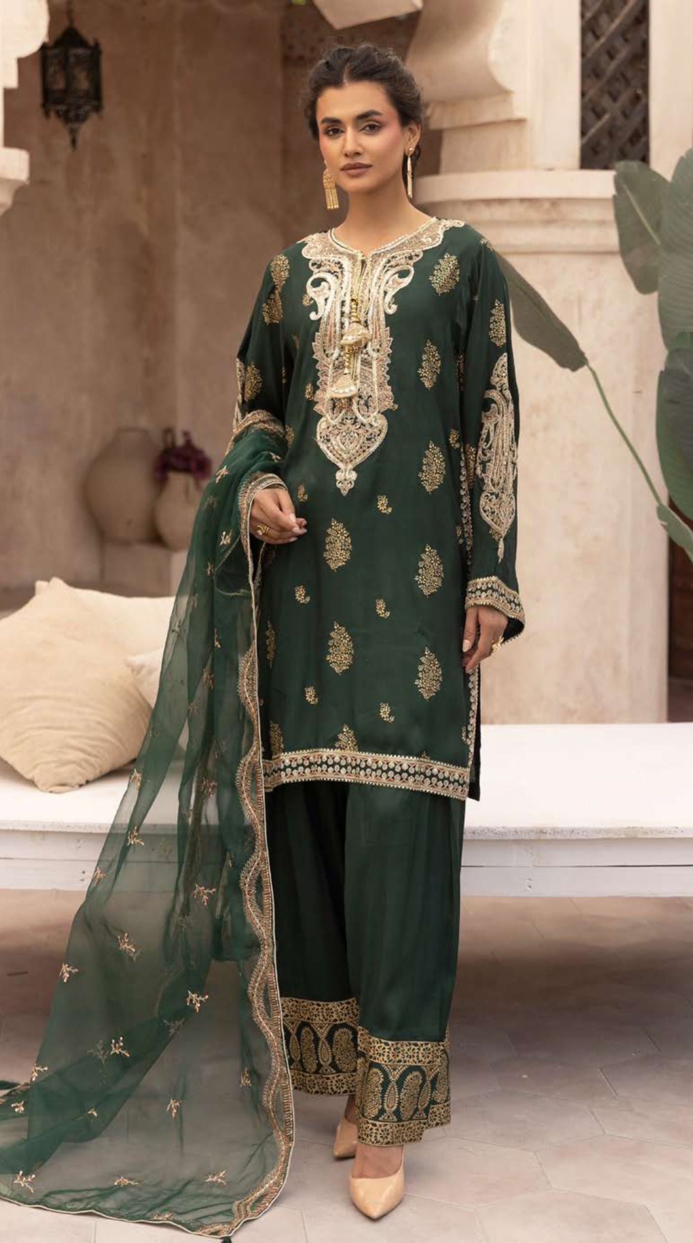 Women's emerald green embroidered viscose suit set with an embellished neckline, embroidered straight-cut kurta, matching bottoms, and a sheer net dupatta.