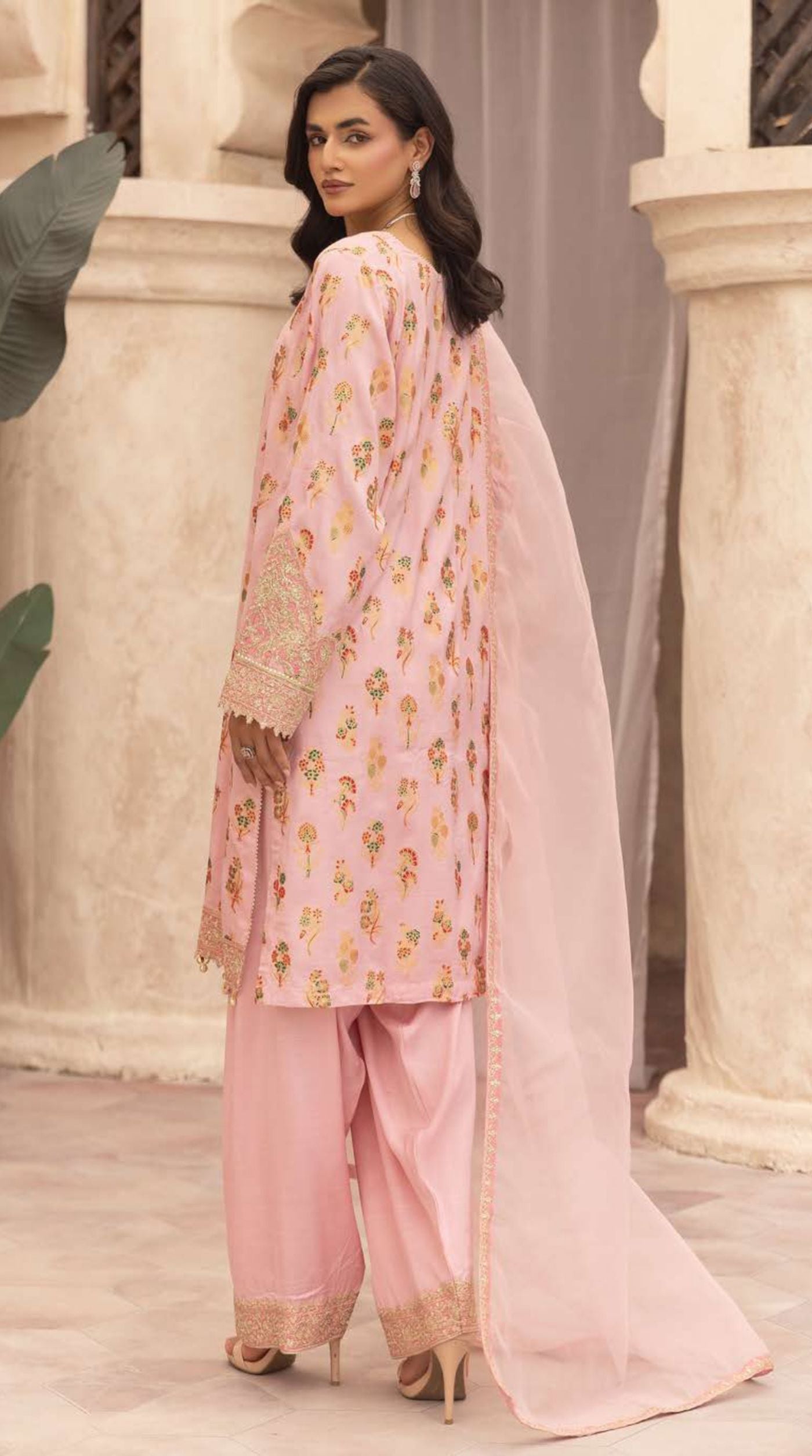 Women's blush pink embroidered viscose suit set featuring floral motifs, embellished cuffs, coordinated bottoms, and a lightweight net dupatta.