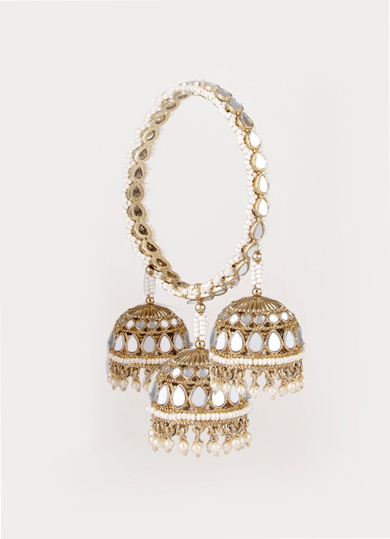 Close-up mirror and pearl detailing on gold colour bangles