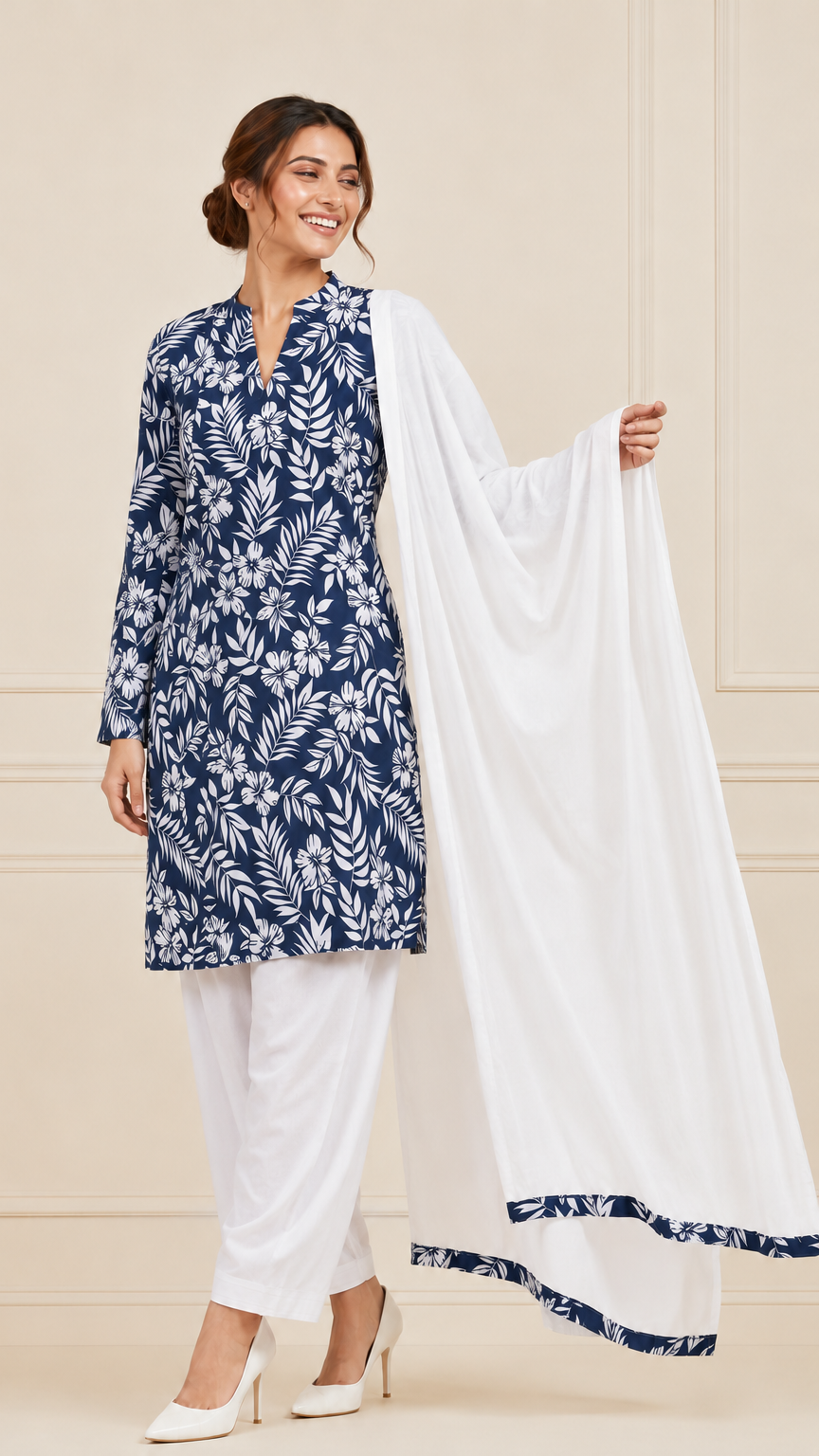 Woman wearing a navy blue and white floral printed kurta set with white trousers and white dupatta – Diya Online ethnic wear.