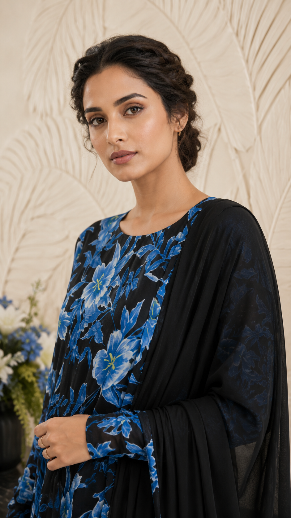 Women's black floral Anarkali dress with vibrant blue flowers and matching dupatta, showcased in a full-length front view highlighting the flowy design and printed detailing. Buy Diya Online