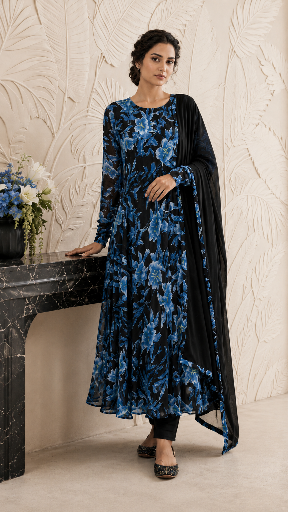 Women's black floral Anarkali dress with vibrant blue flowers and matching dupatta, showcased in a full-length front view highlighting the flowy design and printed detailing. Buy Diya Online