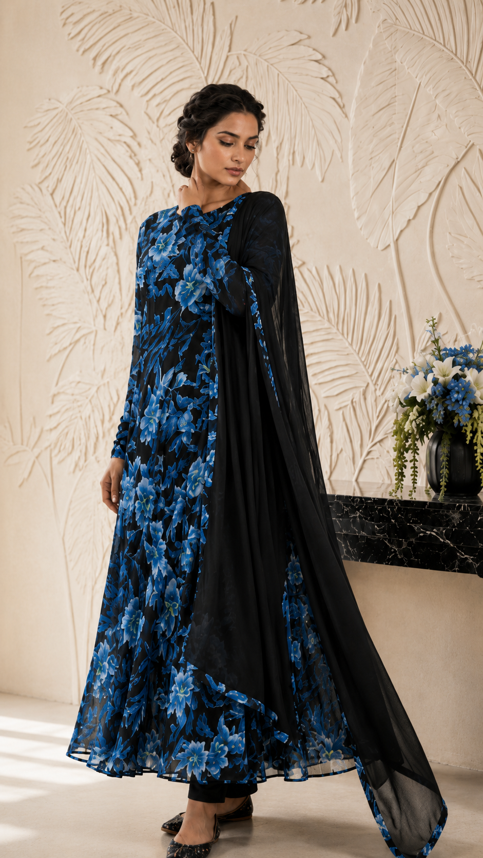 Women's black floral Anarkali dress with vibrant blue flowers and matching dupatta, showcased in a full-length front view highlighting the flowy design and printed detailing. Buy Diya Online