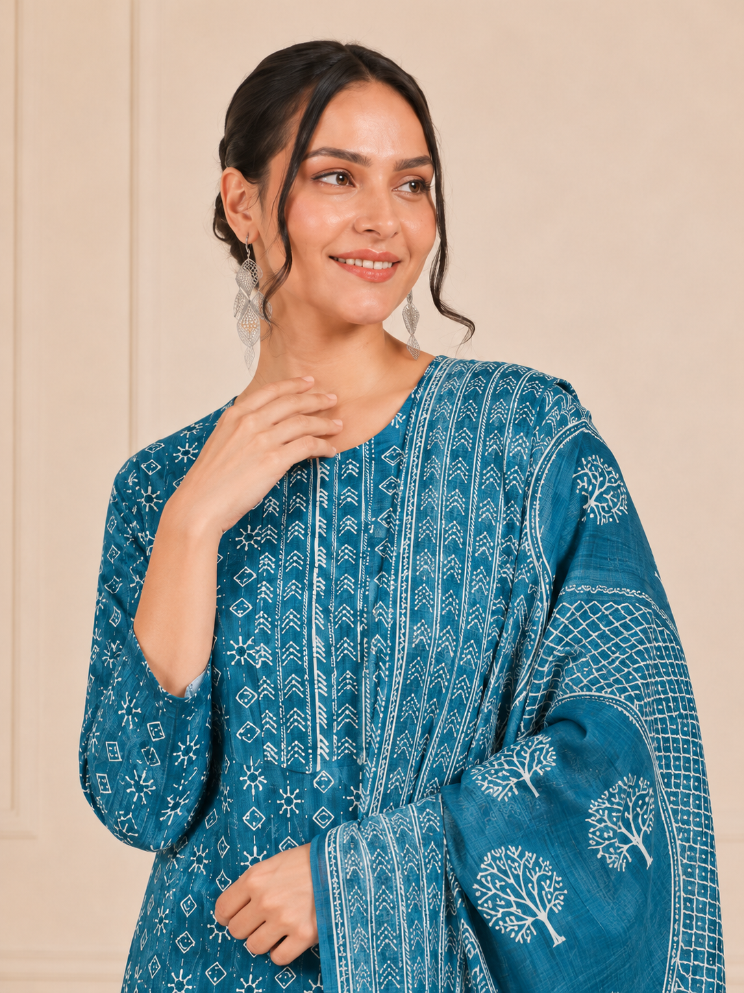 Woman wearing a teal blue and white printed kurta set with matching trousers and printed dupatta – Diya Online ethnic wear.