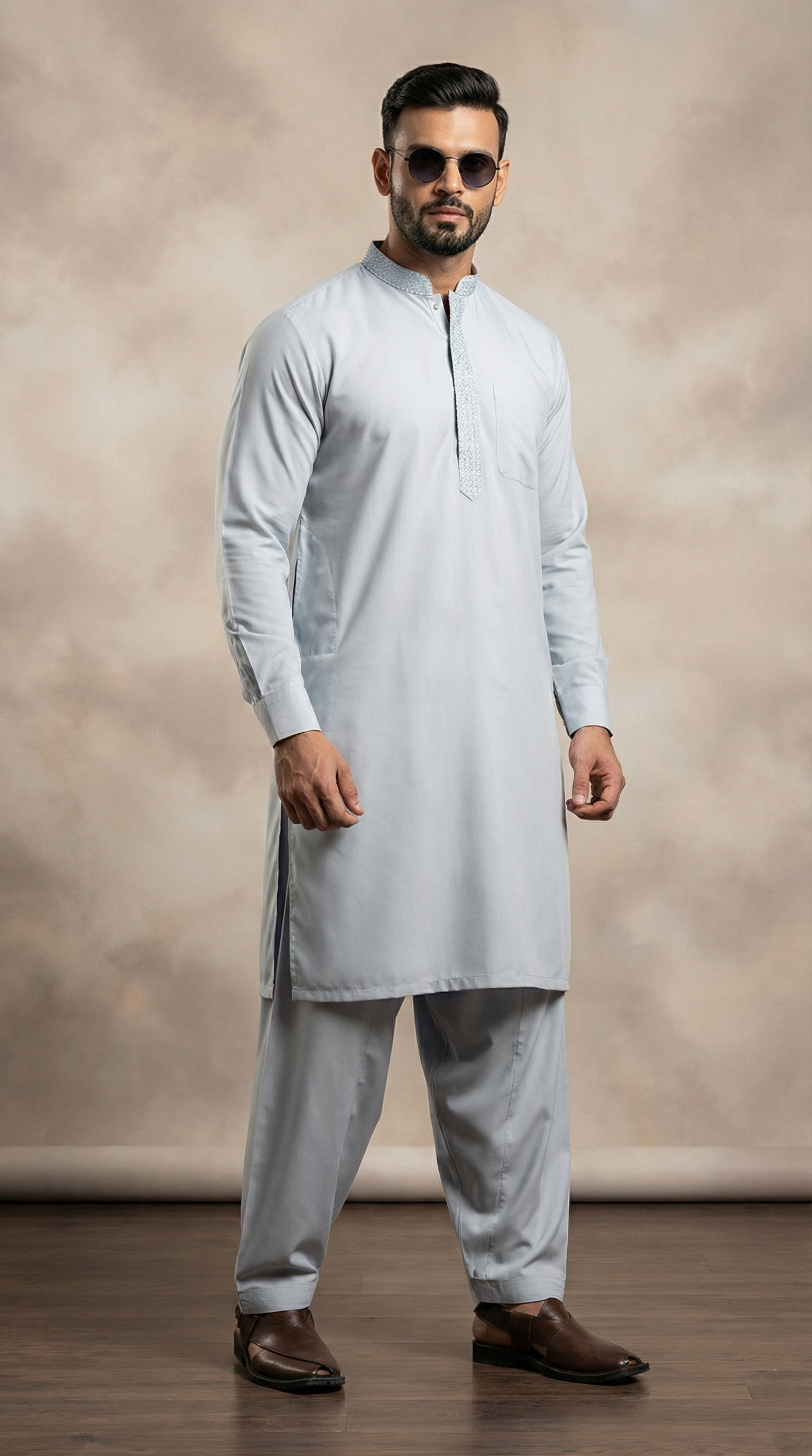 Light blue men’s shalwar kameez featuring embroidered placket and loose fit trousers, traditional South Asian outfit