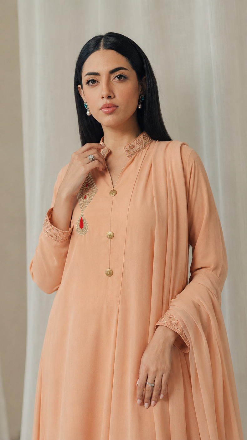 Peach women’s embroidered Anarkali salwar kameez suit with matching trousers and flowing chiffon dupatta, elegant Asian ethnic wear by Diya Online