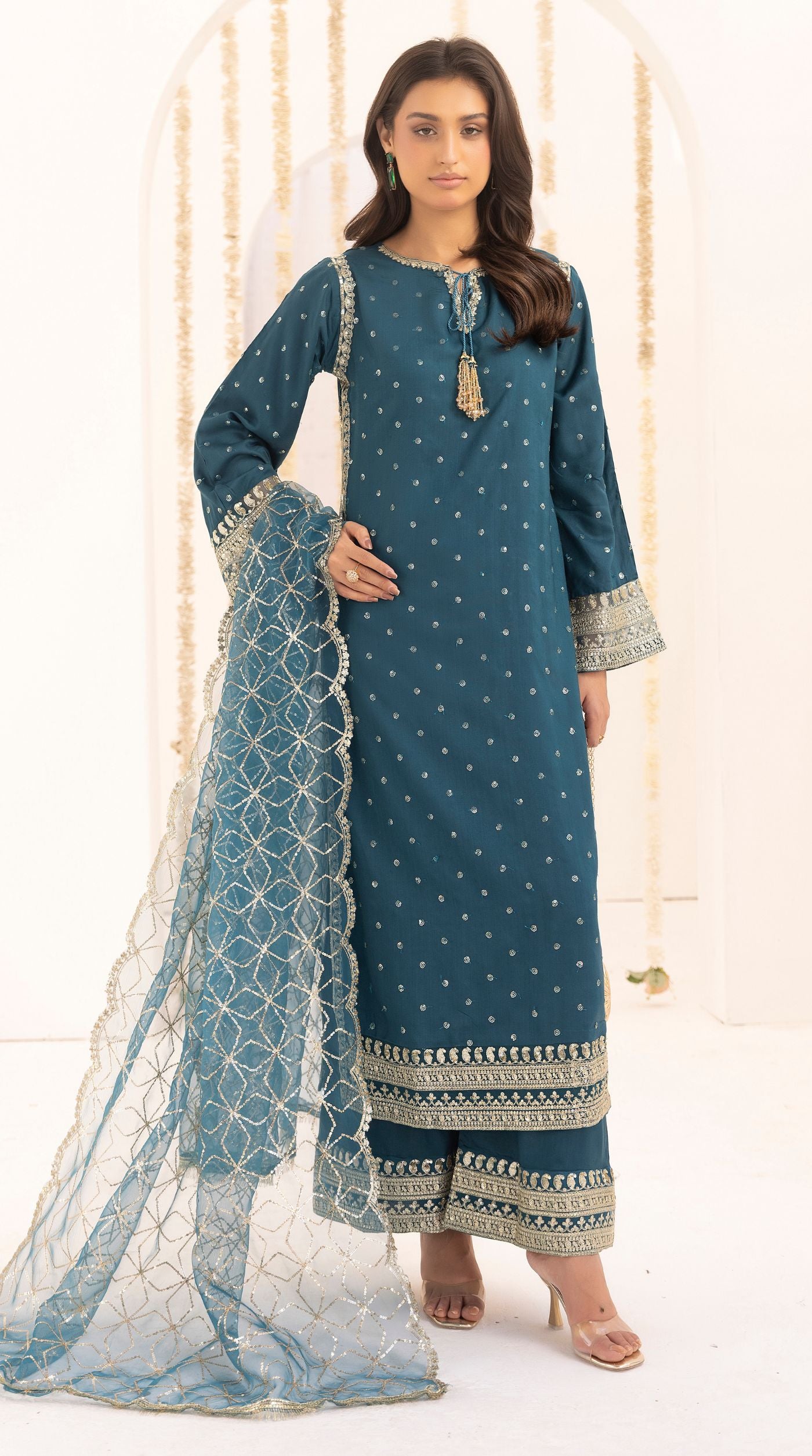 Teal embroidered viscose suit set with embellished detailing and an intricately embroidered net dupatta.