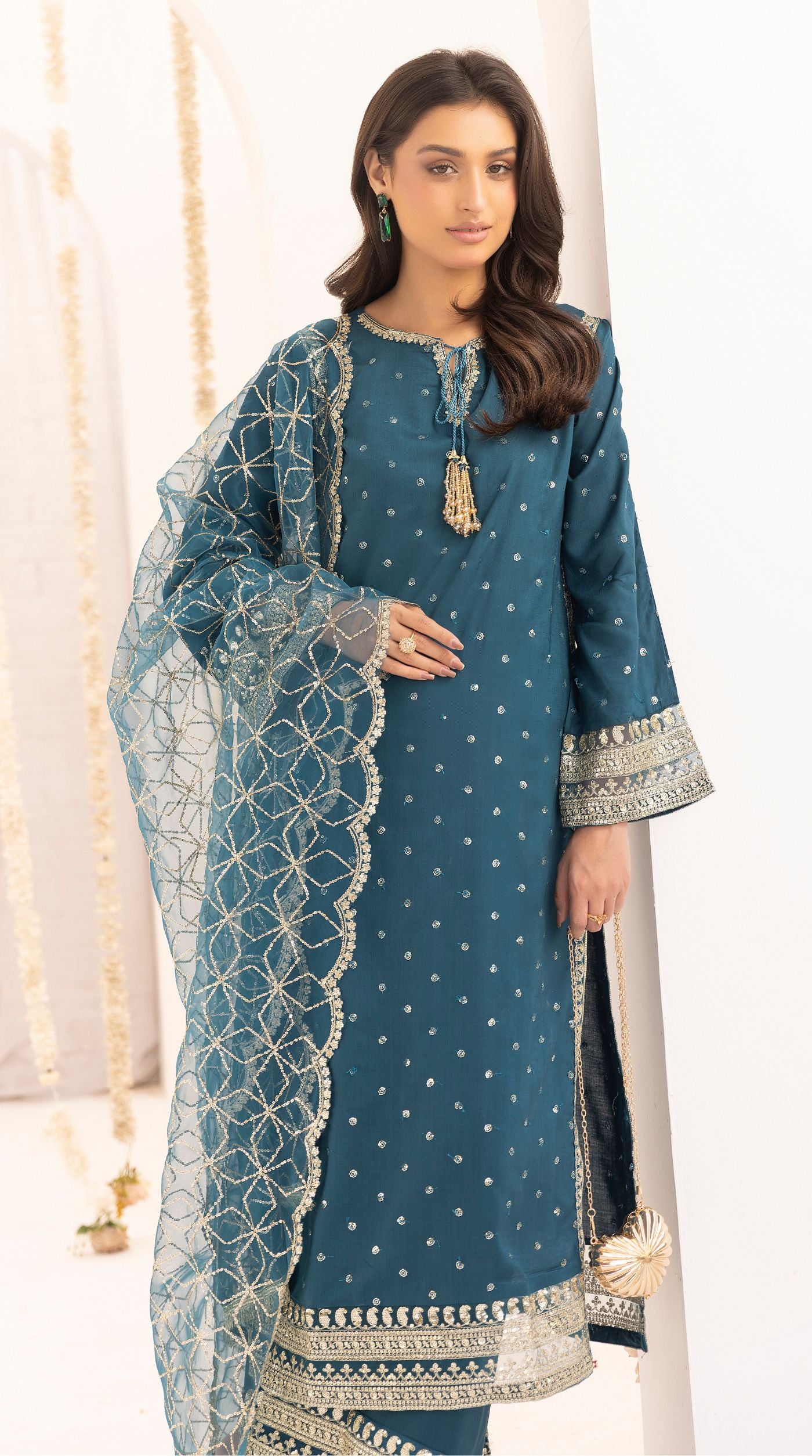 Teal embroidered viscose suit set with embellished detailing and an intricately embroidered net dupatta.