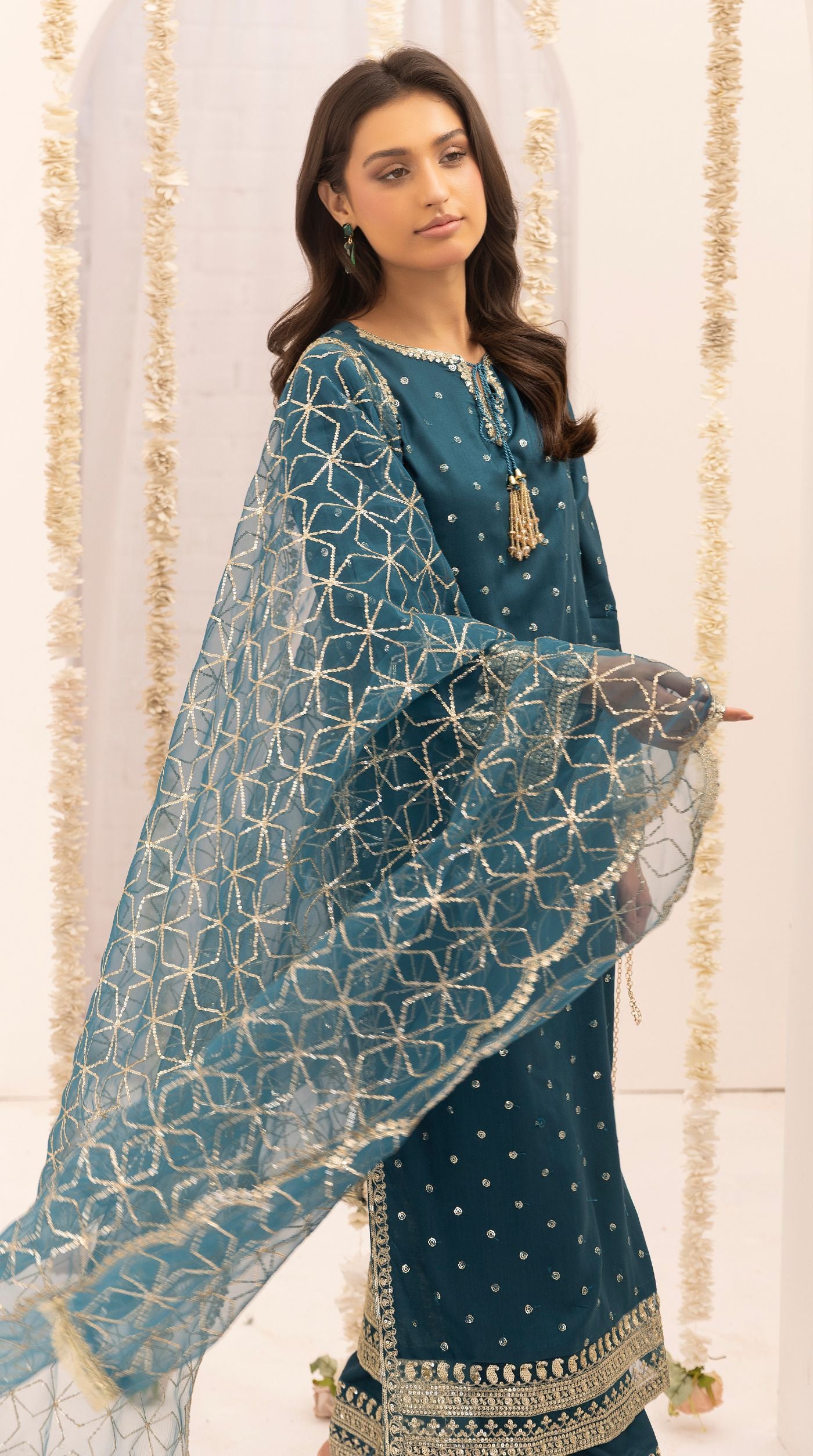 Teal embroidered viscose suit set with embellished detailing and an intricately embroidered net dupatta.