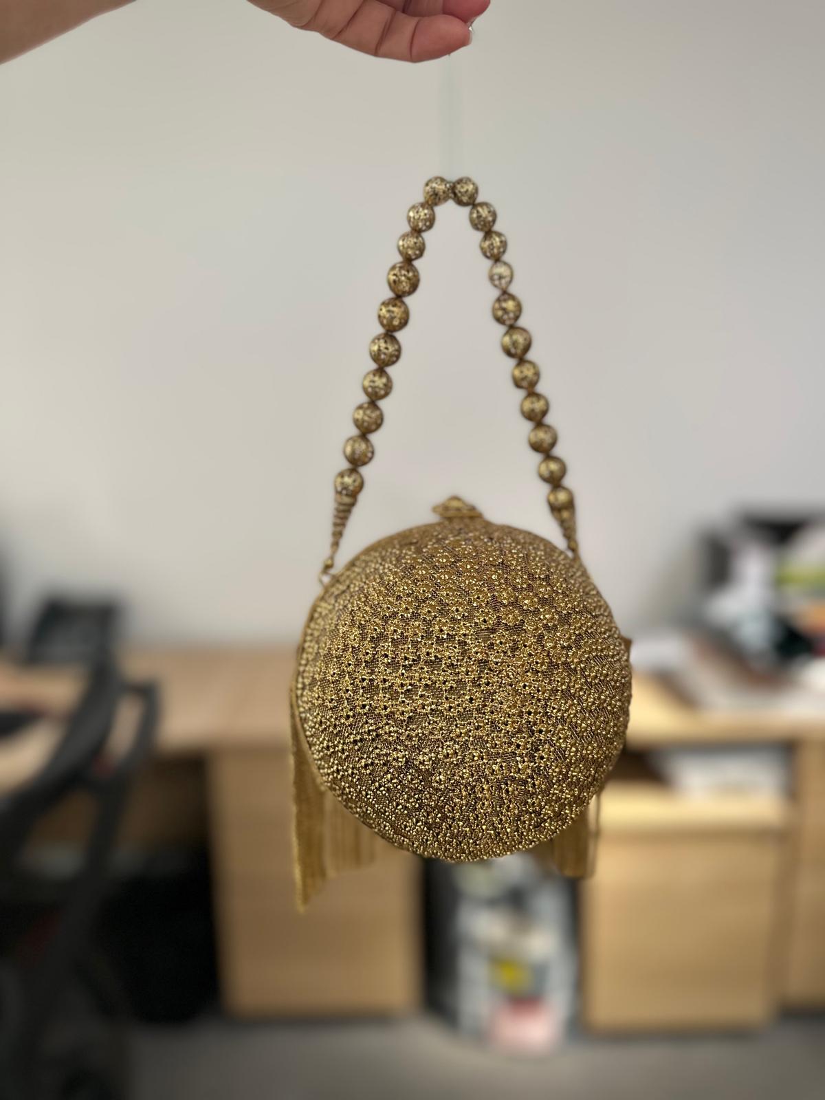 Round Metallic Carved Potli Bag