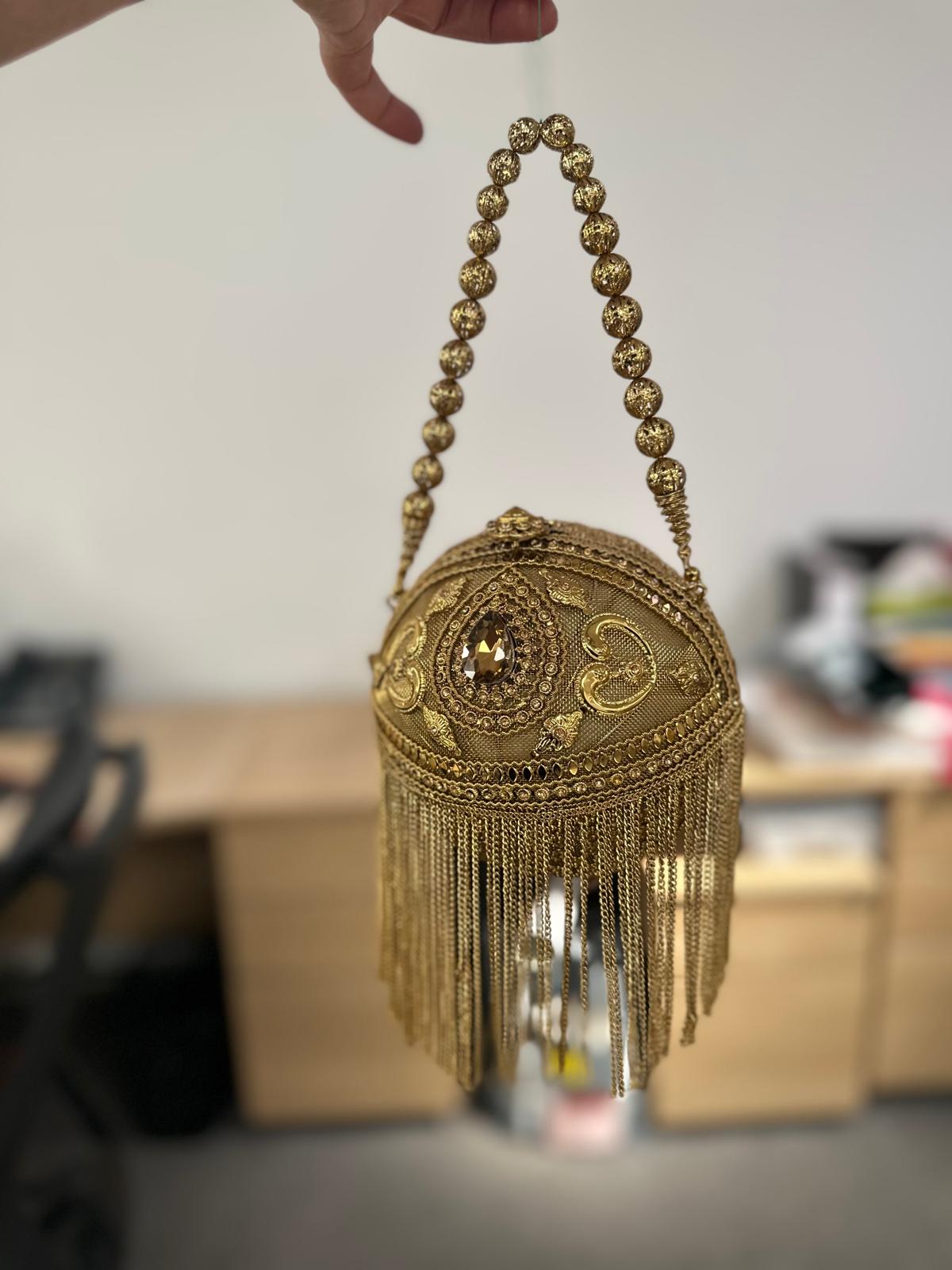 Round Metallic Carved Potli Bag