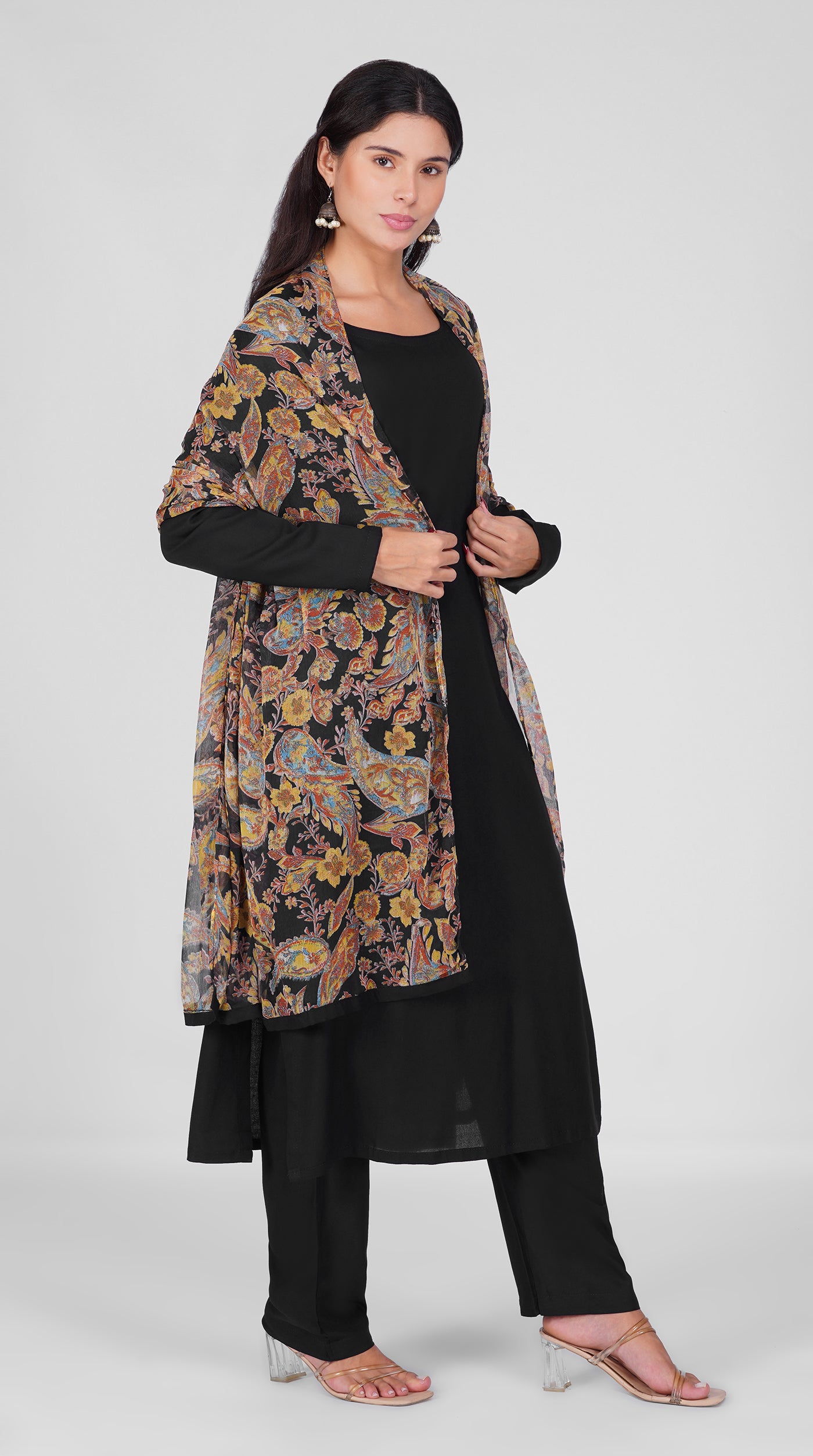 Black straight cut suit set modeled with a plain black kurta and pants paired with a sheer vintage paisley and floral printed georgette dupatta 