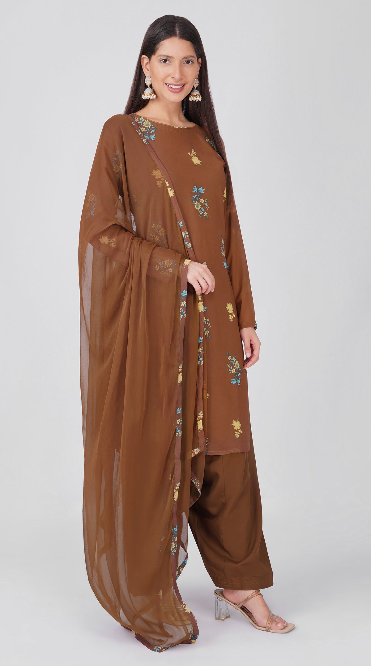 Women’s brown georgette printed suit set with shift kurta, crepe salwar and chiffon dupatta featuring four-sided printed patti detailing.