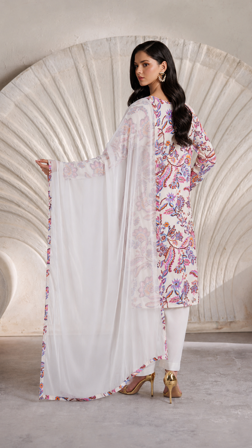 Buy white multicolour floral print Pakistani salwar kameez with loose trousers and matching sheer dupatta for women online at Diya Online.