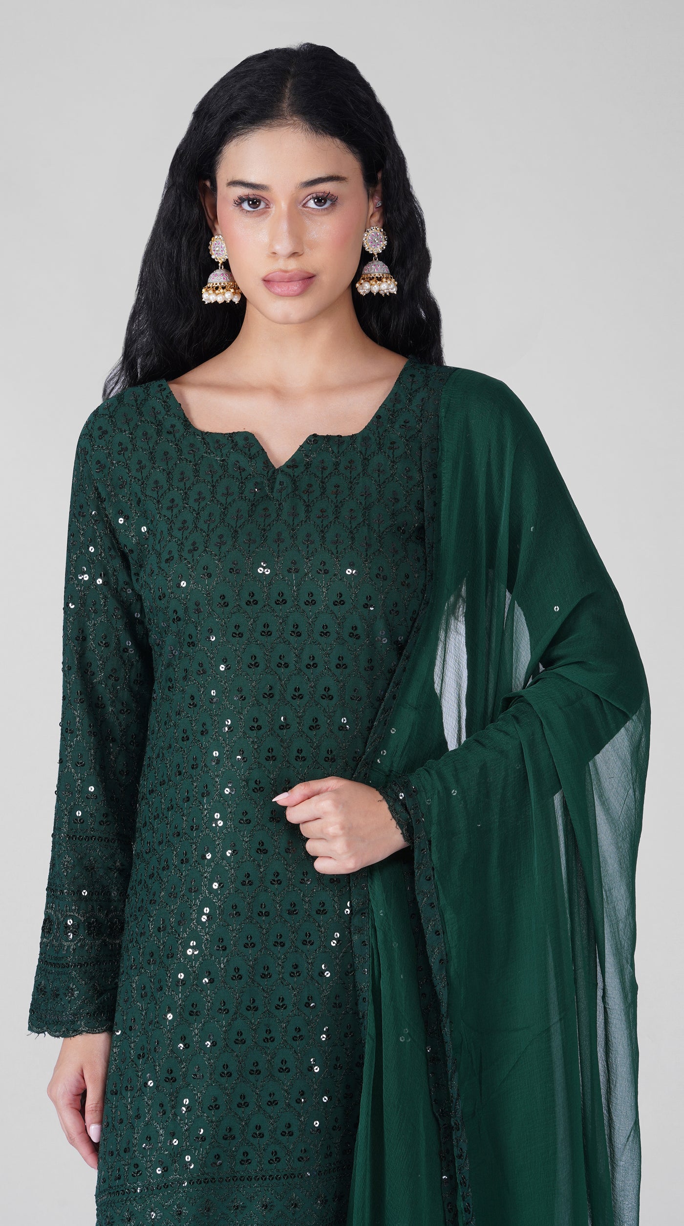 Close-up of Chikankari embroidery on dark green kurta