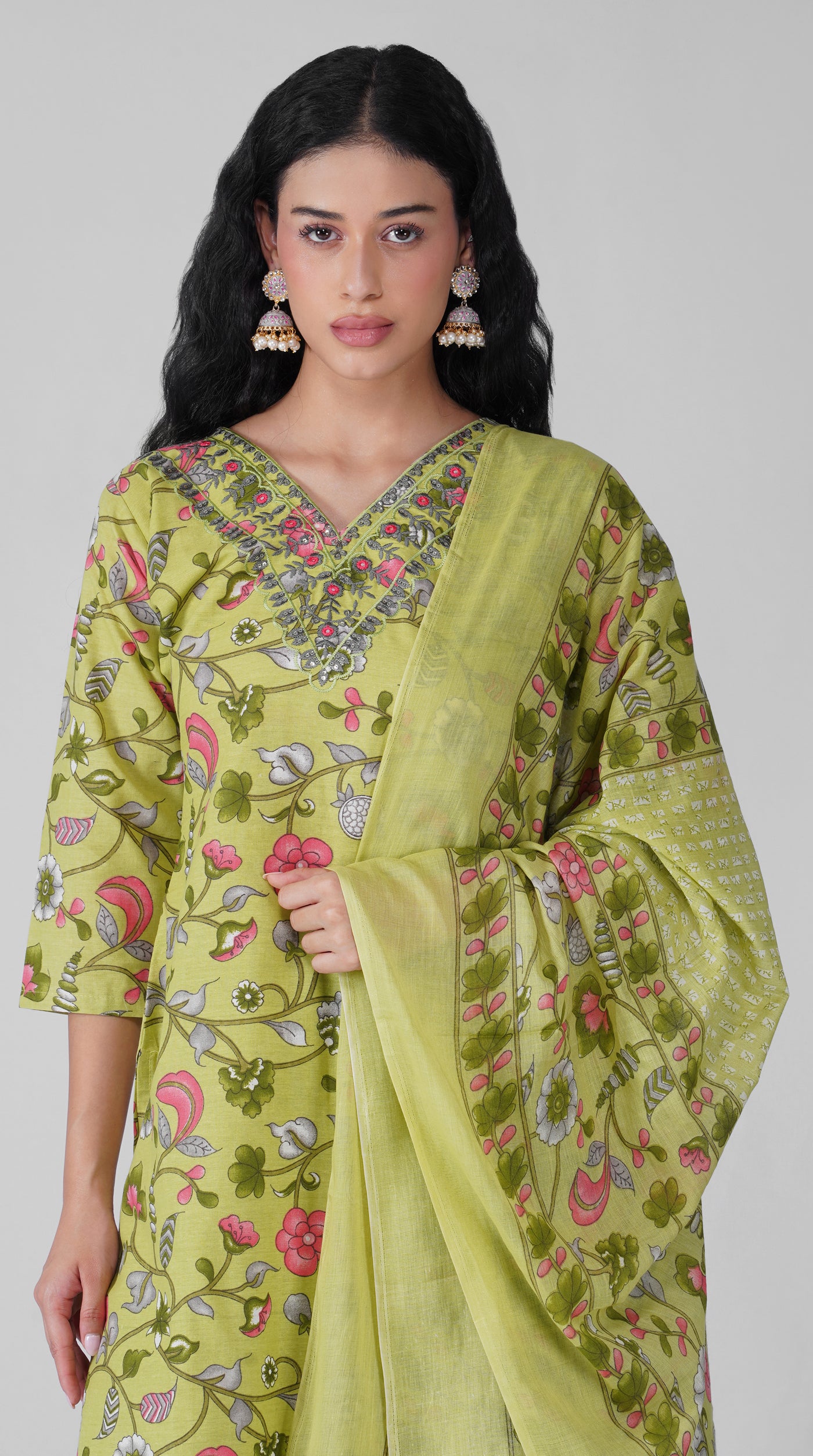 Close-up of floral print and embroidered neckline on green cotton kurta