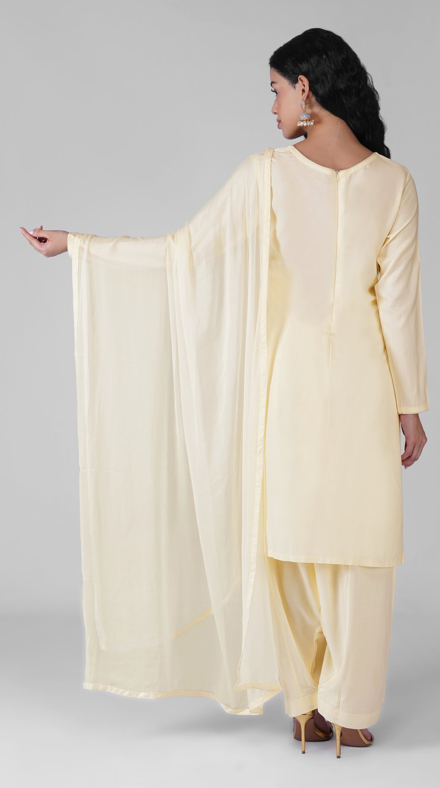 Side profile of plain ivory rayon suit with chiffon dupatta