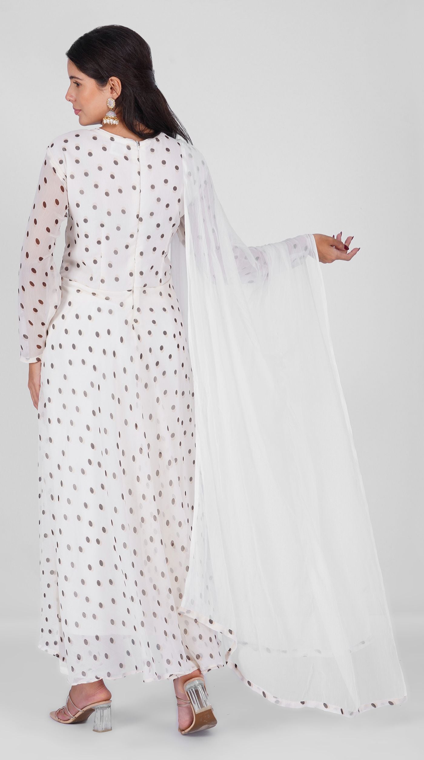 Woman wearing a white georgette bias cut suit set with black polka dot print, white crepe trousers, and printed chiffon dupatta – Diya Online