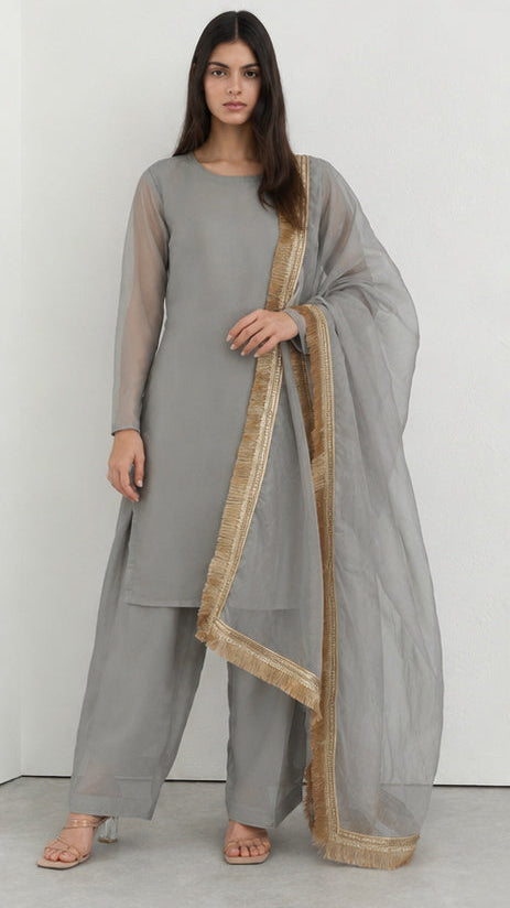 Grey printed georgette salwar suit styled with gold fringe organza dupatta