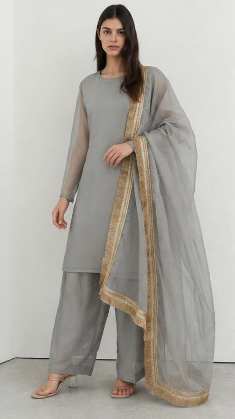 Grey printed georgette salwar suit styled with gold fringe organza dupatta