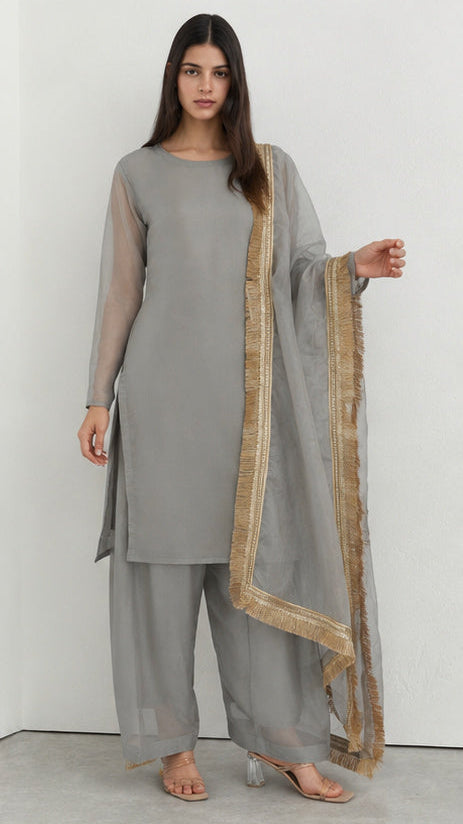 Grey printed georgette salwar suit styled with gold fringe organza dupatta