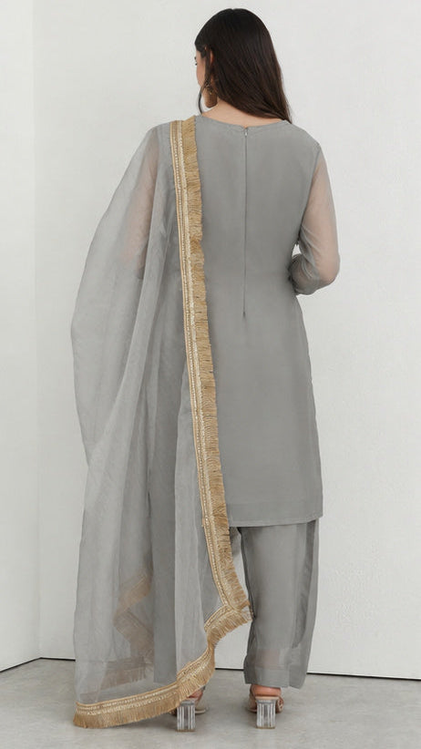 Grey printed georgette salwar suit styled with gold fringe organza dupatta