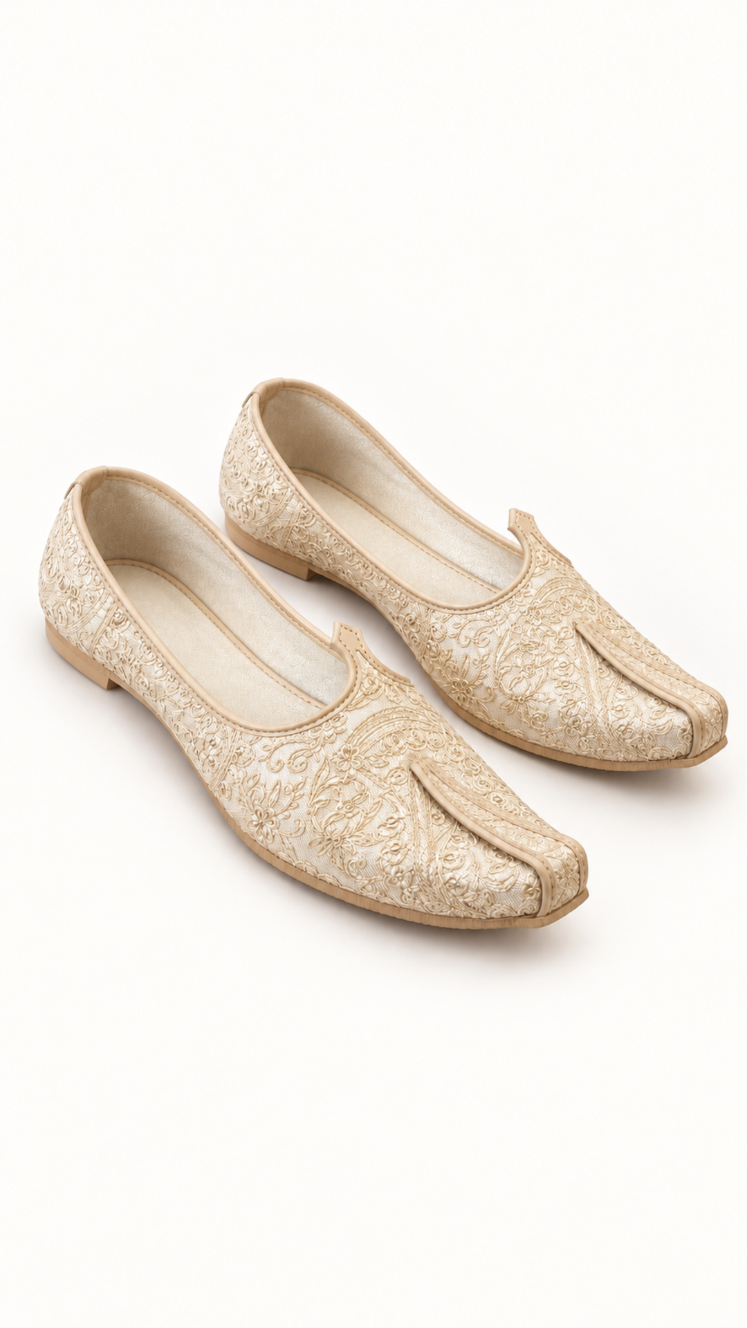 A pair of traditional Ivory embroidered flat shoes with a pointed toe and decorative tassel detail, displayed on a clean white background.