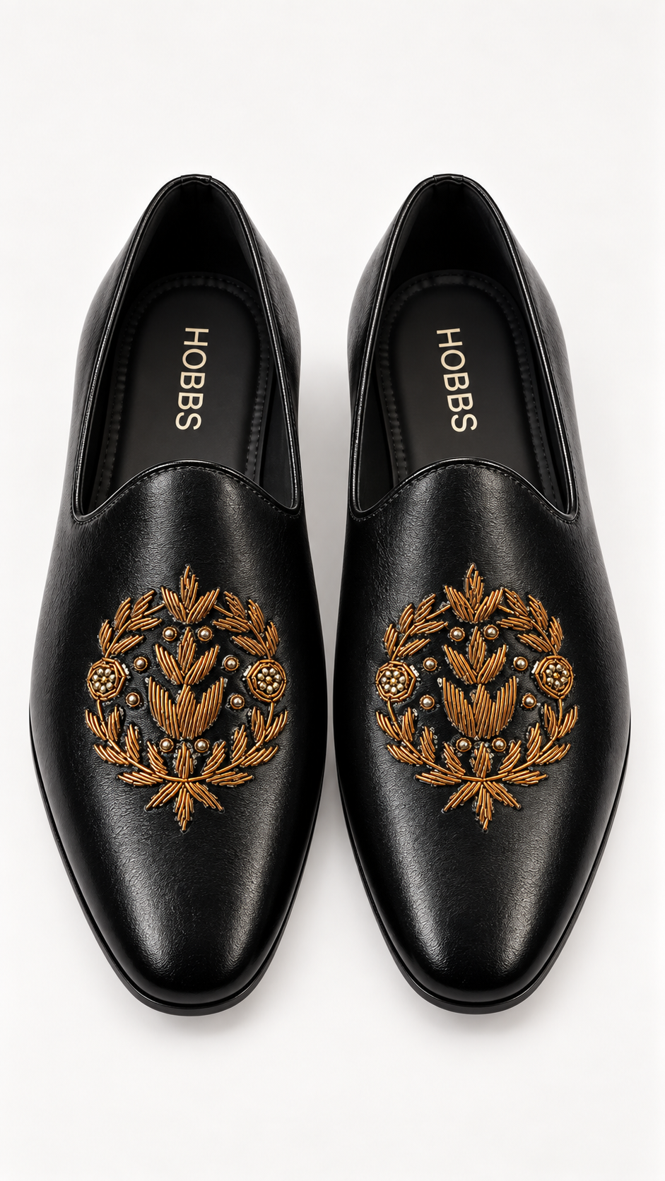 A pair of black leather slip-on loafers with gold embroidered floral and leaf motifs.