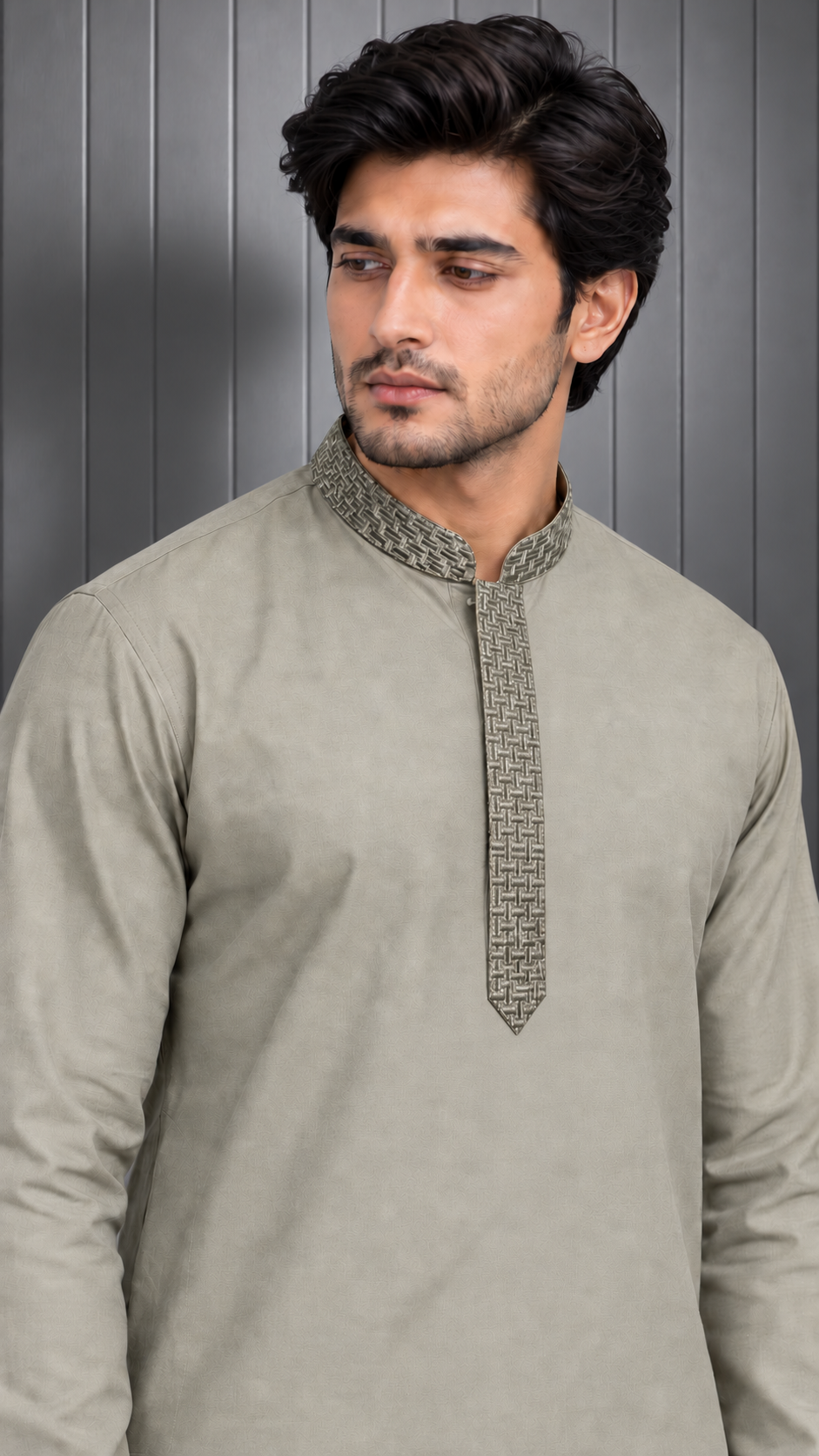 A man wearing a light beige long-sleeve kurta with a textured patterned collar and placket, set against a dark gray paneled background.