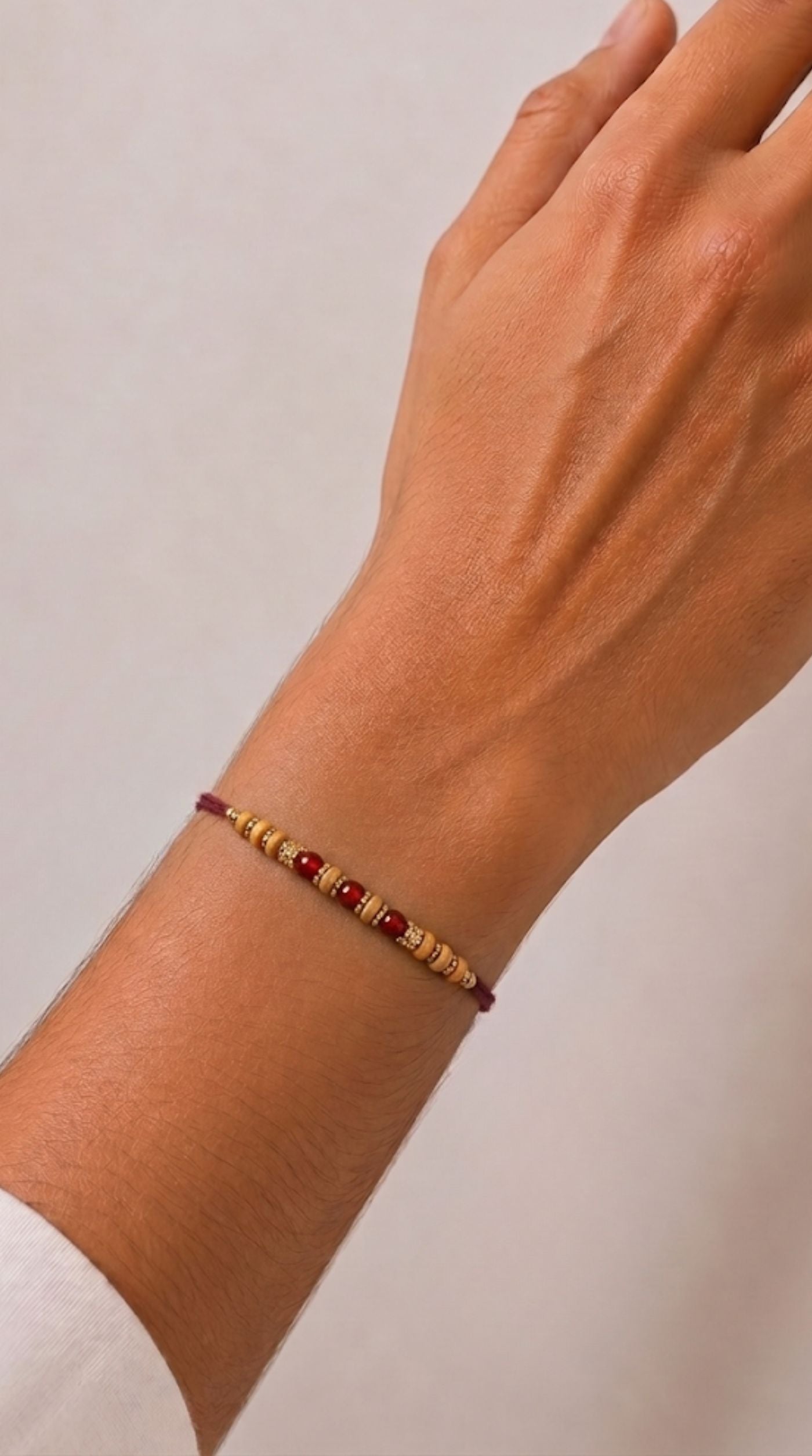 Wood and bead Rakhi with maroon centre beads
