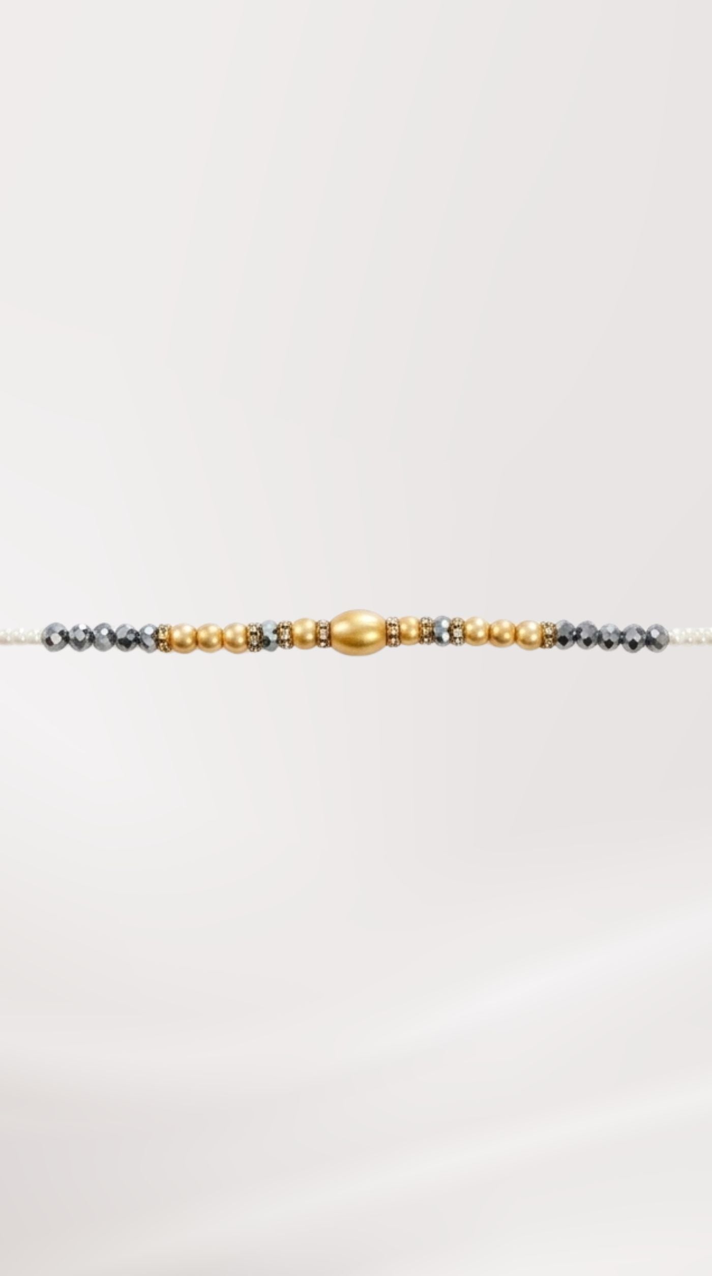 Close-up of grey bead adjustable Rakhi bracelet on wrist