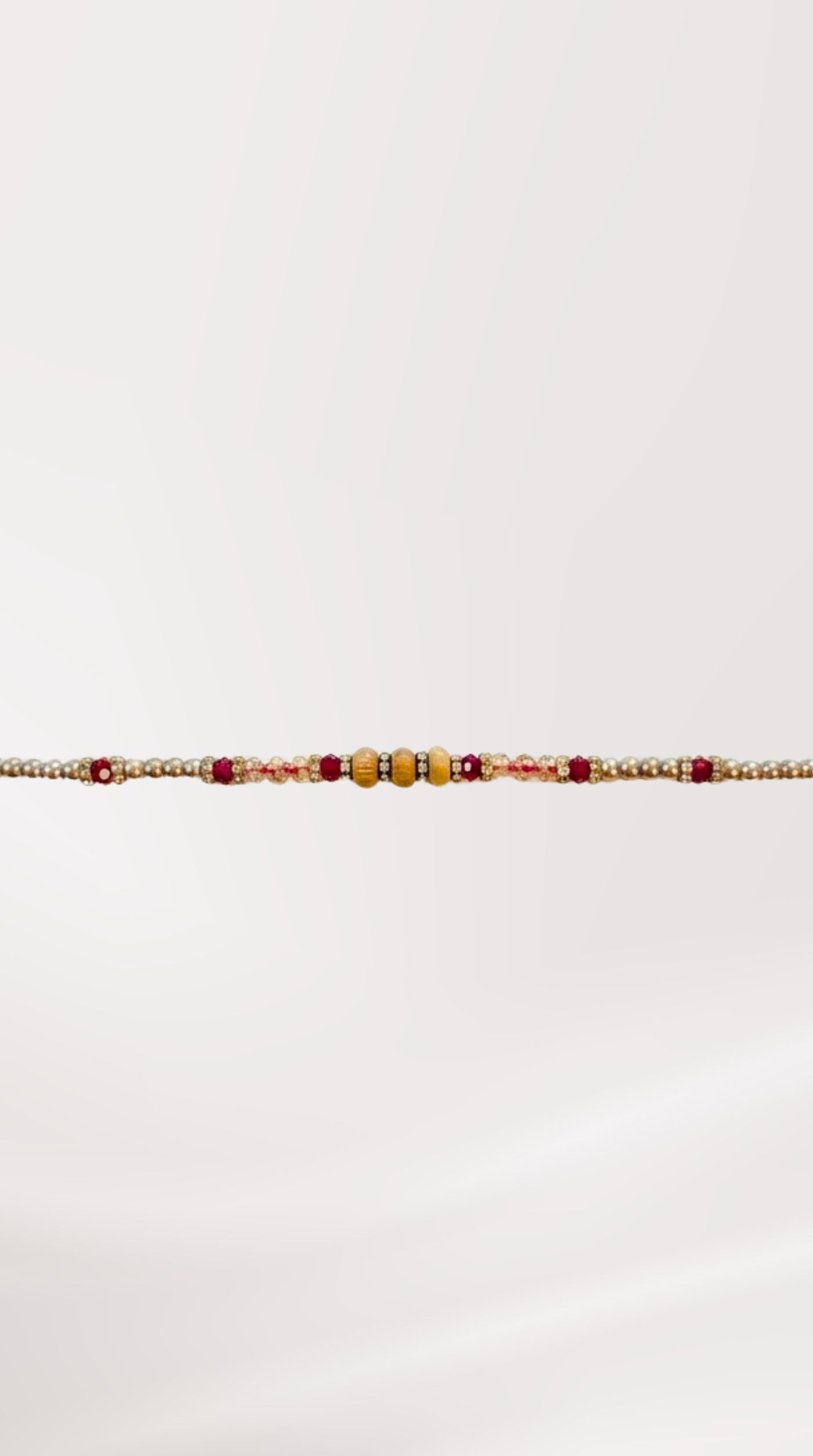 Close-up of brown stone chain Rakhi bracelet on wrist