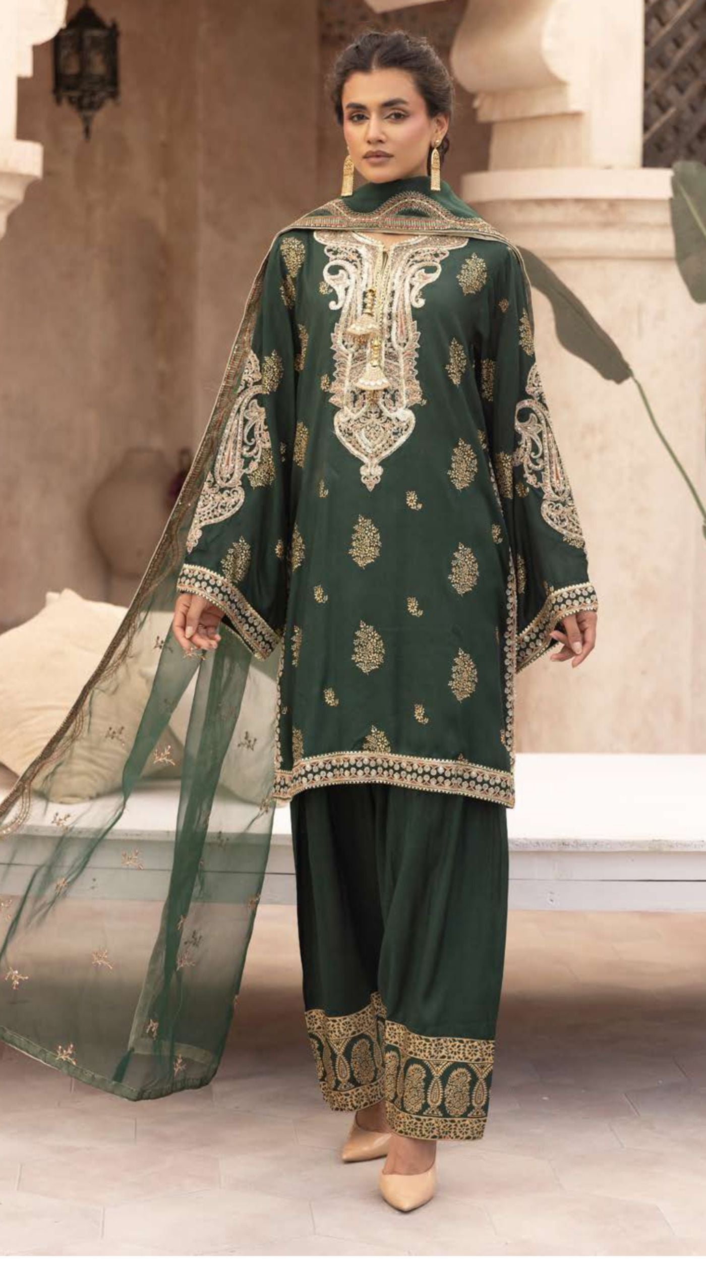 Women's emerald green embroidered viscose suit set with an embellished neckline, embroidered straight-cut kurta, matching bottoms, and a sheer net dupatta.
