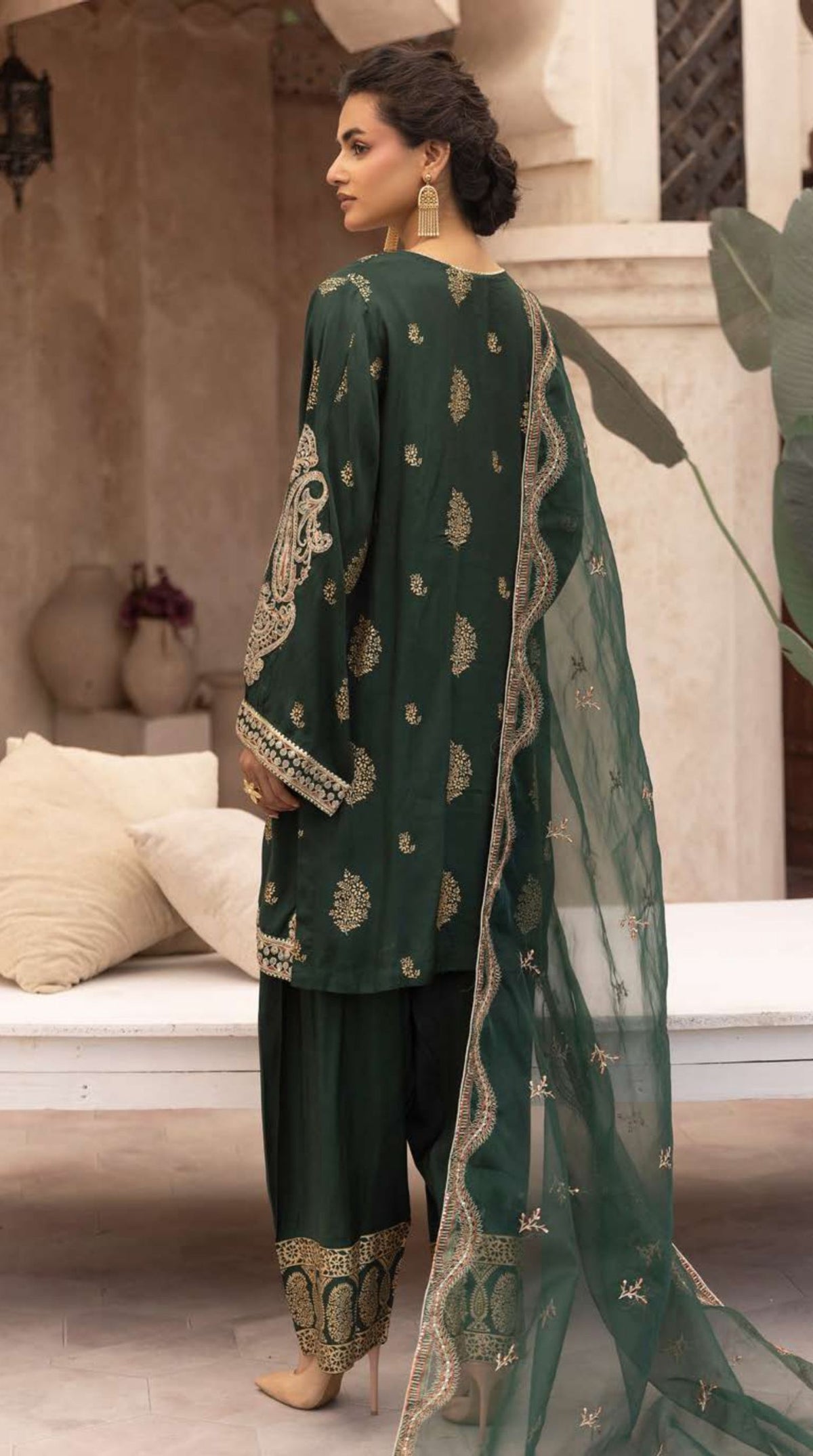 Women's emerald green embroidered viscose suit set with an embellished neckline, embroidered straight-cut kurta, matching bottoms, and a sheer net dupatta.