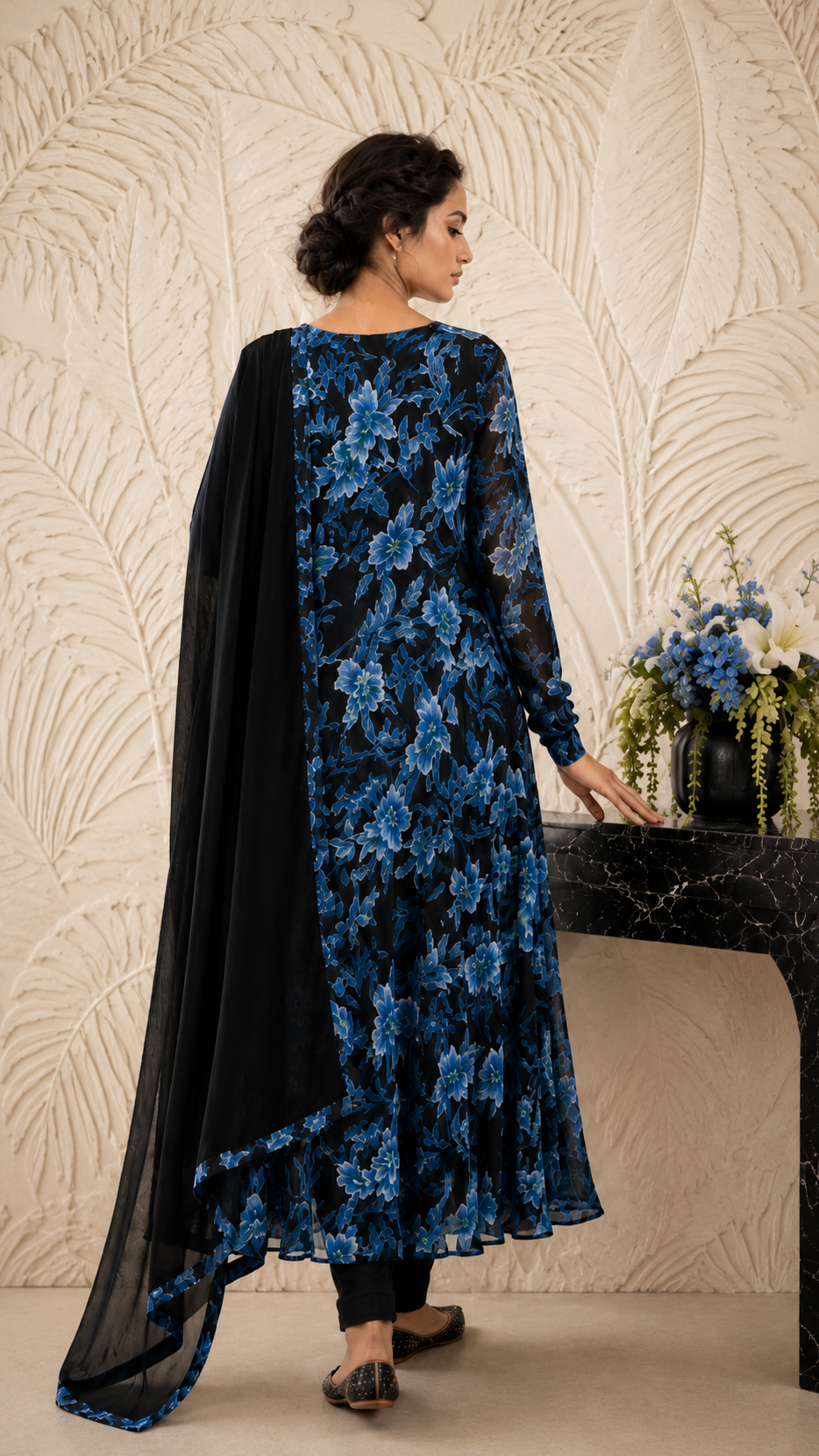 Women's black floral Anarkali dress with vibrant blue flowers and matching dupatta, showcased in a full-length front view highlighting the flowy design and printed detailing. Buy Diya Online